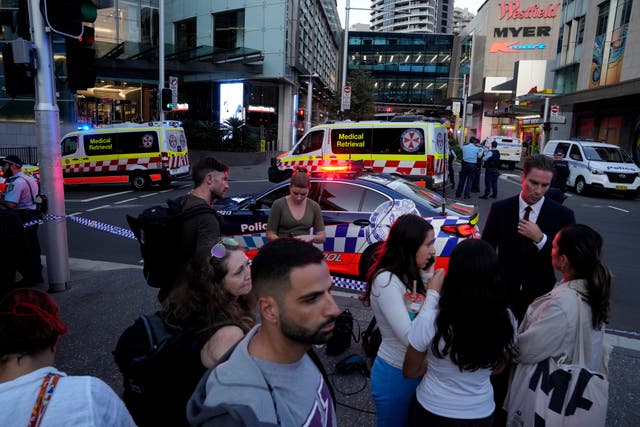 <p>A crowd gathers outside Westfield Shopping Centre in Sydney (AP Photo/Rick Rycroft)</p>