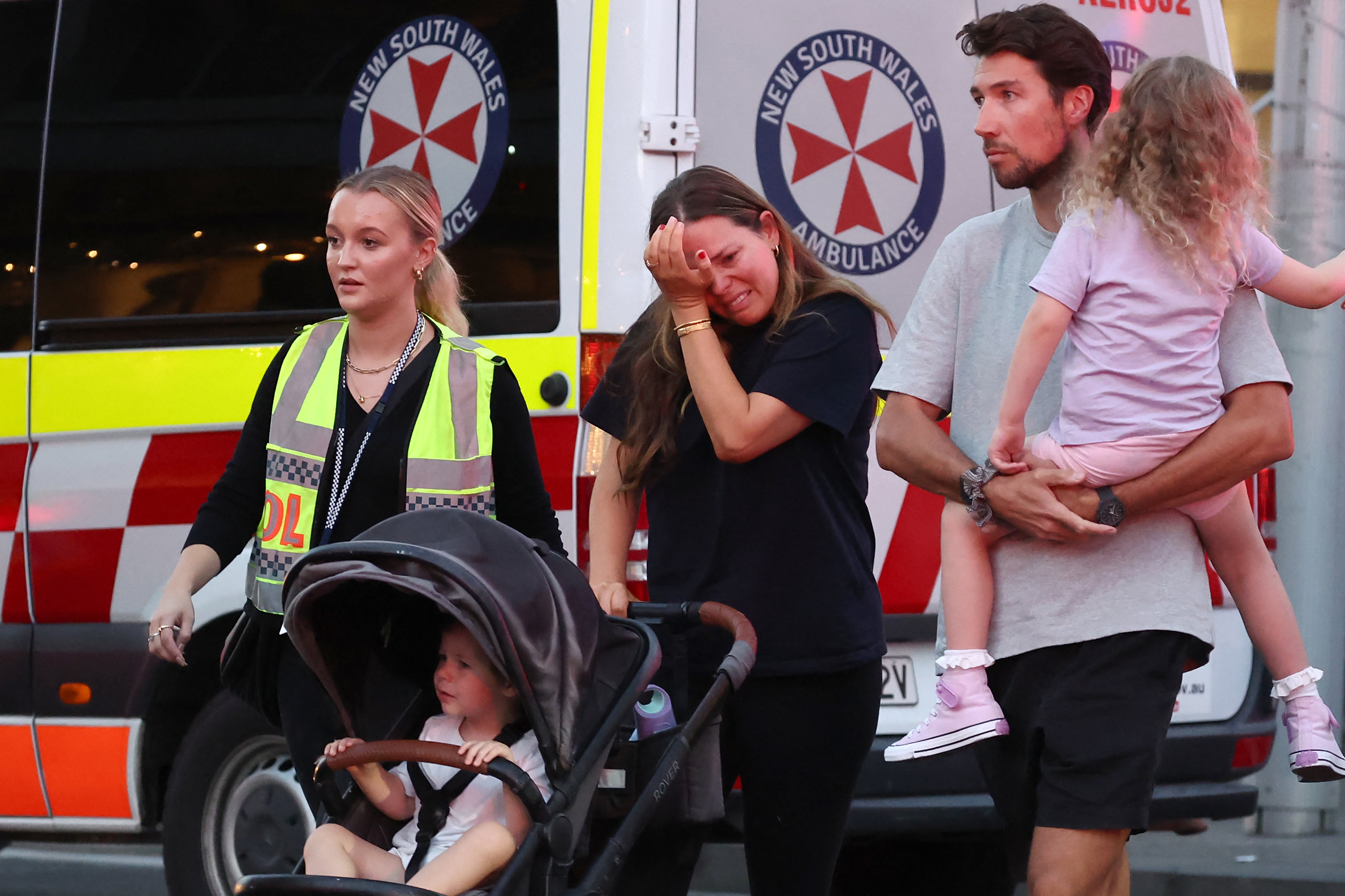 A woman cries as she comes out of the Westfield mall after the stabbing attack