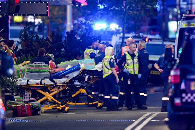<p>Police officers and emergency service workers are seen at Bondi Junction</p>