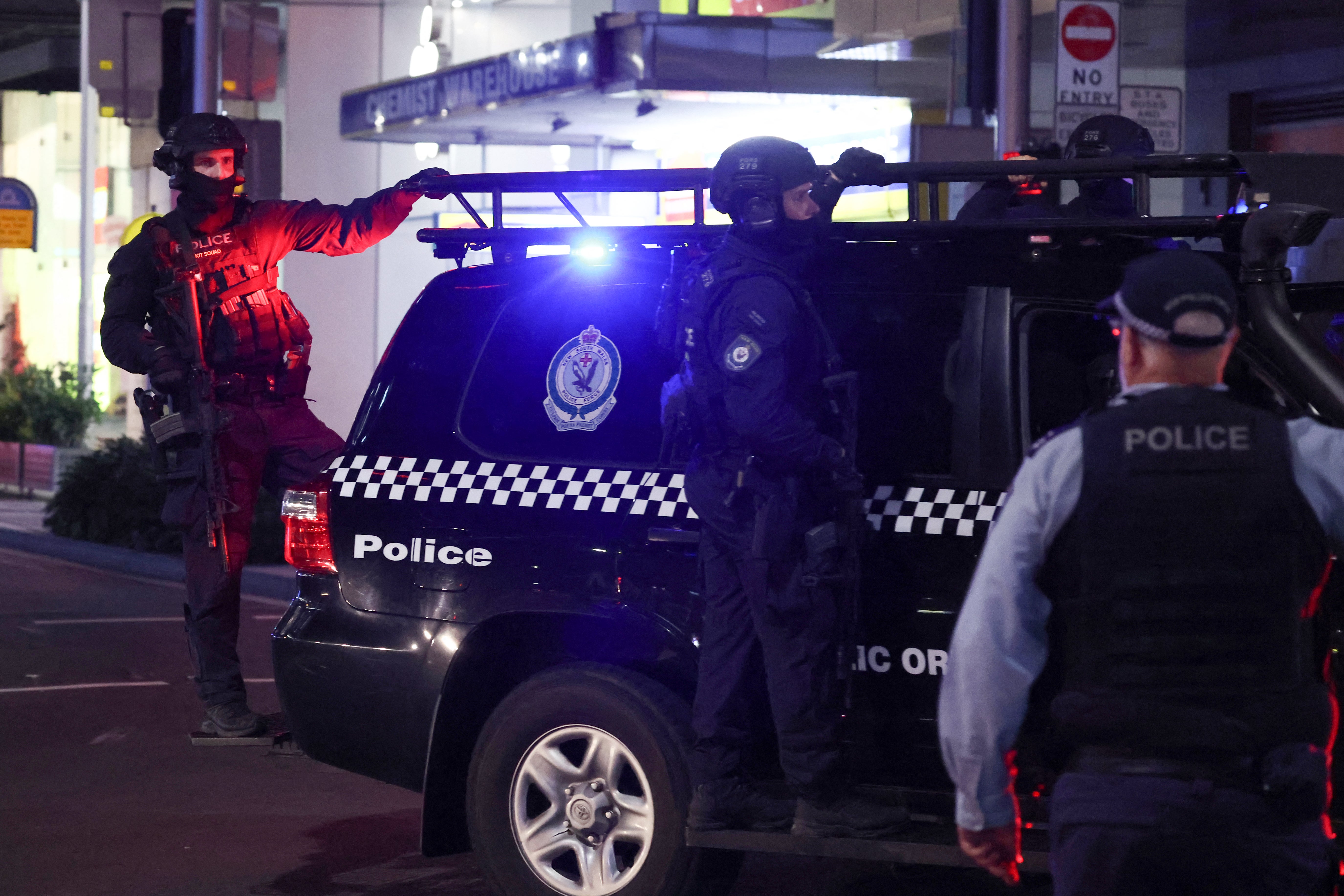 Police patrol in front of the Westfield shopping mall after the stabbing attack