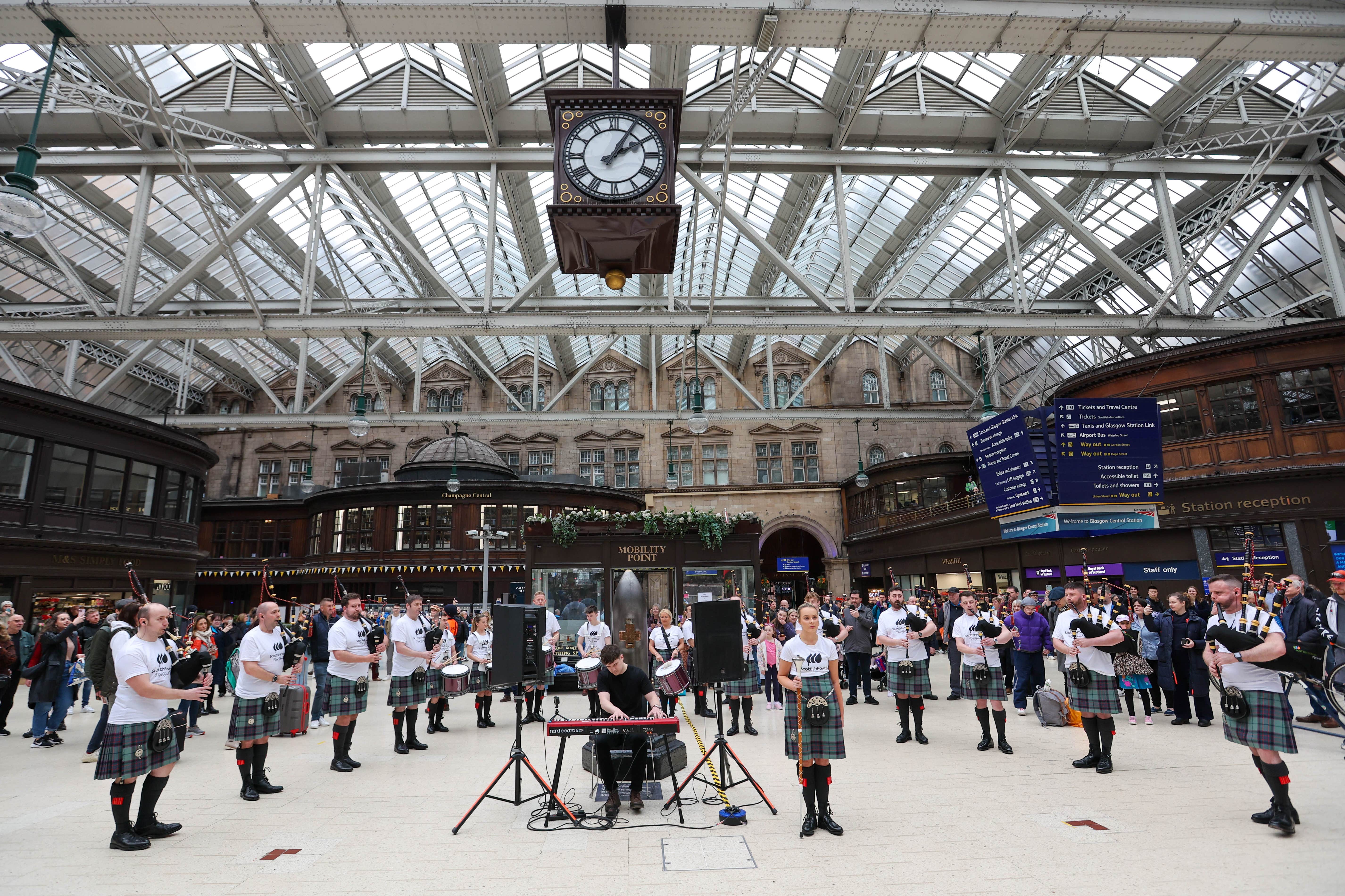 The ScottishPower Pipe Band performed a surprise set for passengers at Glasgow Central Station (ScottishPower/PA)