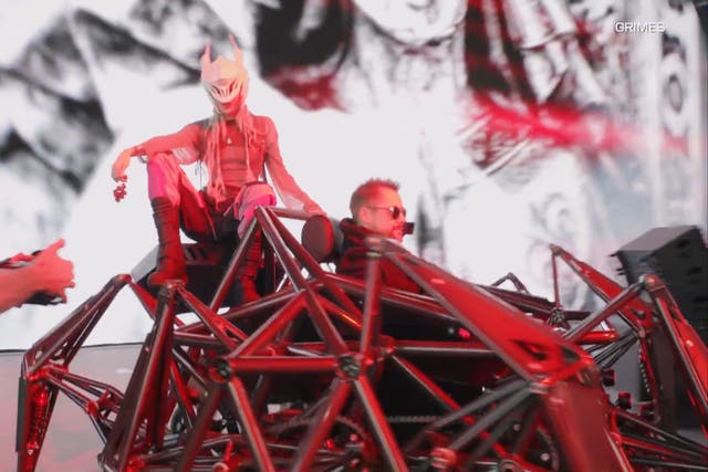 <p>Grimes arrives onstage at Coachella atop a robotic vehicle</p>