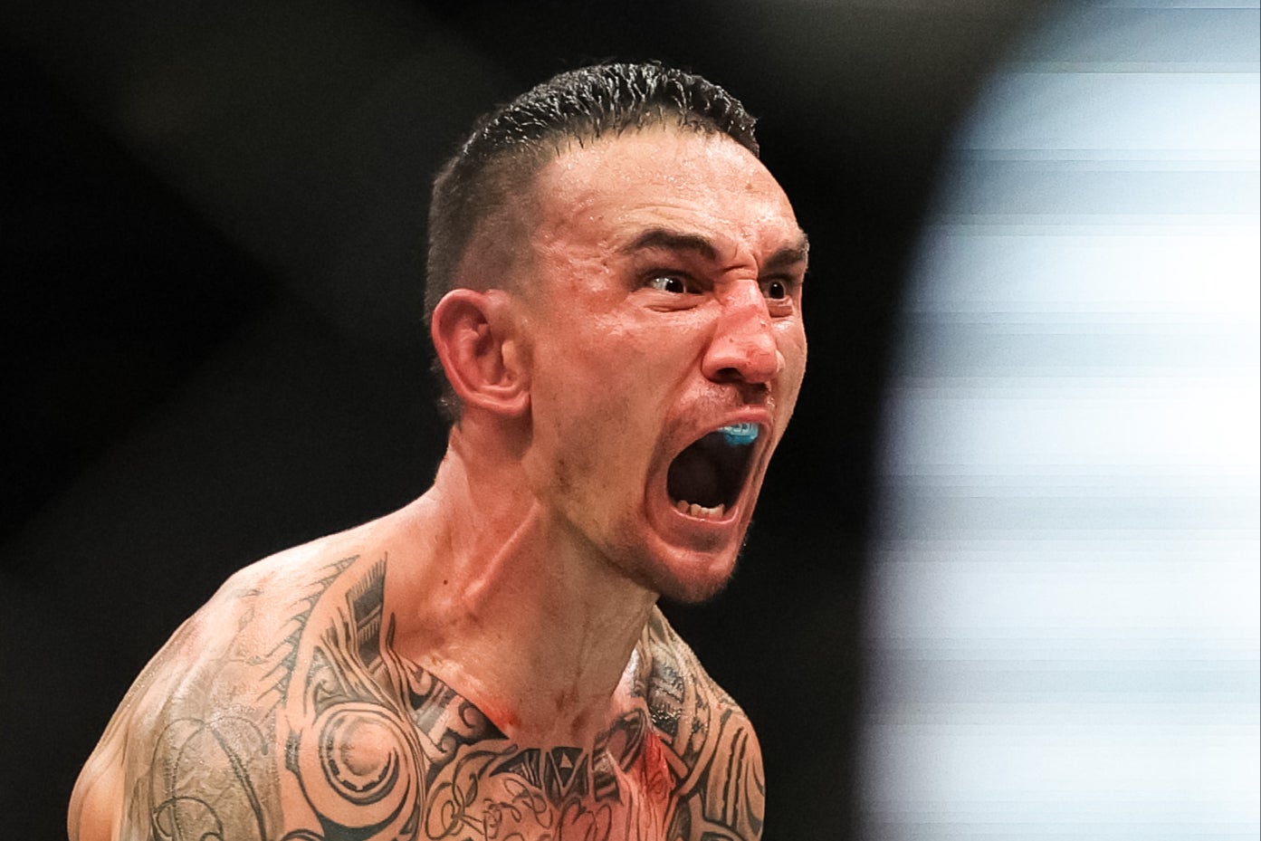 Max Holloway celebrates his knockout of Justin Gaethje at UFC 300