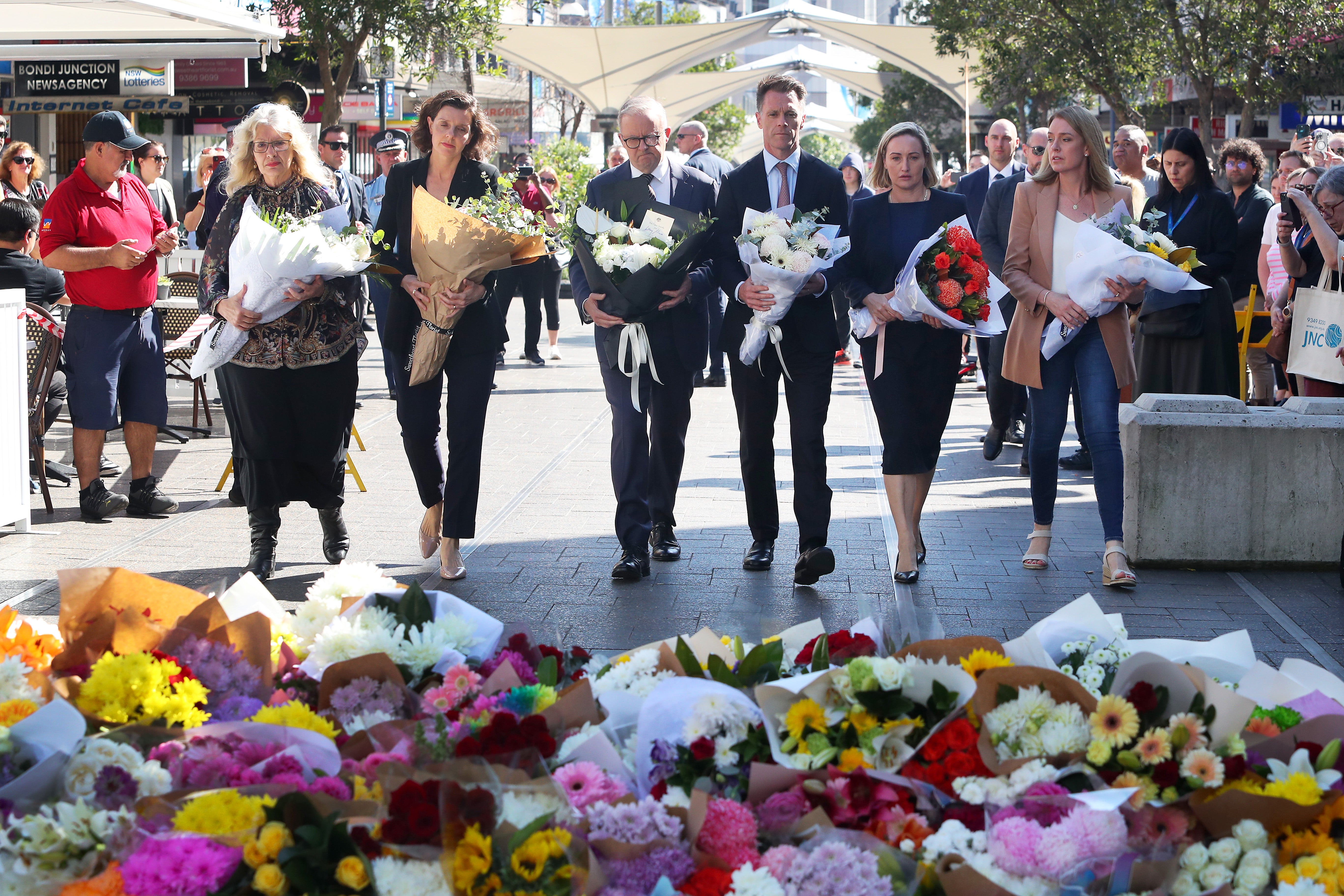 Australian prime minister Anthony Albanese and New South Wales premier Chris Minns lay floral tributes at Westfield Bondi Junction on 14 April 2024