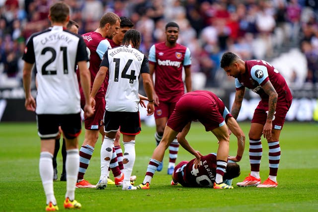West Ham players come to the aid of team-mate George Earthy as he lies injured (Bradley Collyer/PA)