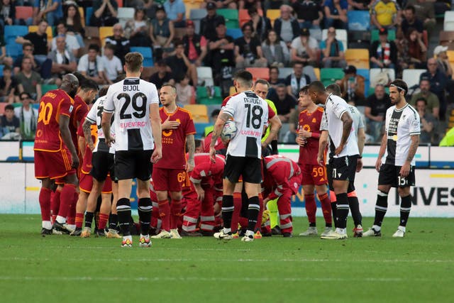 Roma’s Evan Ndicka receives treatment on the pitch after collapsing during the Serie A clash with Udinese (Andrea Bressanutti/AP)