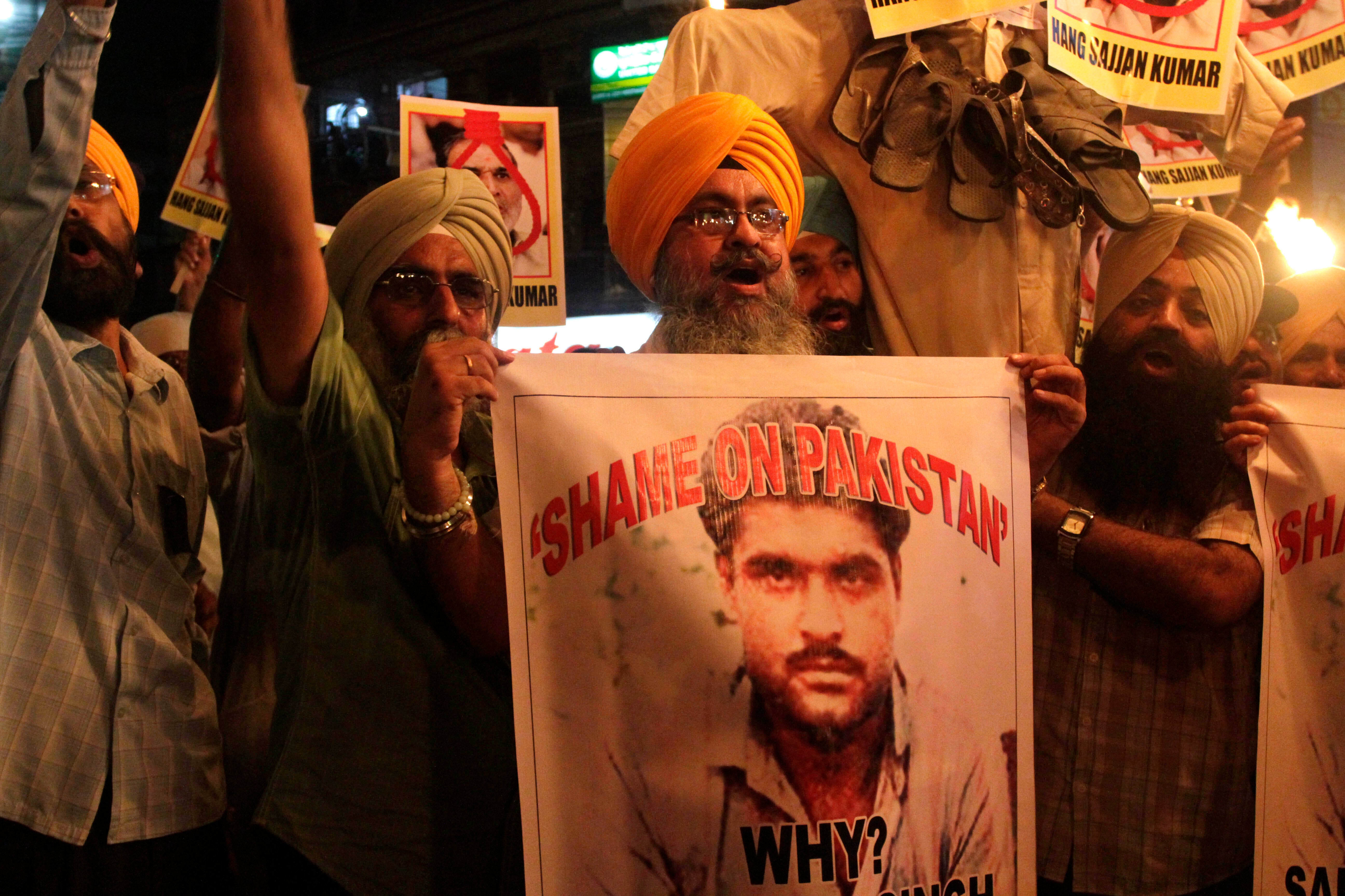 Indian Sikhs shout slogans against Pakistan as they display photographs of Sarabjit Singh, a convicted Indian spy who died from a head injury after two inmates attacked him with a brick in a Lahore jail