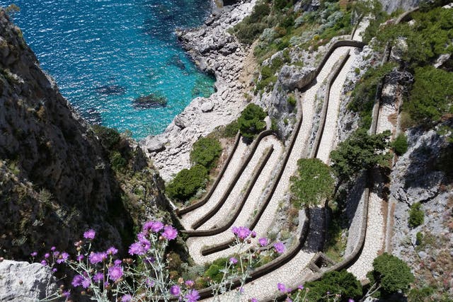 <p>A picture shows a path to a small bay on Capri island in the Italian Gulf of Naples</p>
