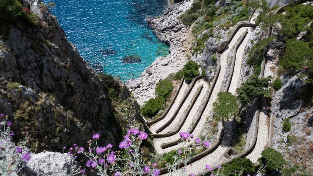 <p>A picture shows a path to a small bay on Capri island in the Italian Gulf of Naples</p>