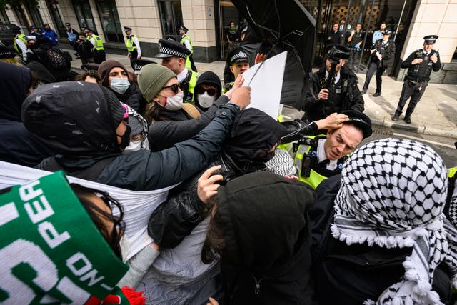 <p>Protestors scuffle with the police as they are moved from the entrance to One Curzon, a building owned by property company London Metric, who also rent buildings to weapons manufacturers Elbit, Boeing and BAE Systems, on April 15, 2024 in London</p>