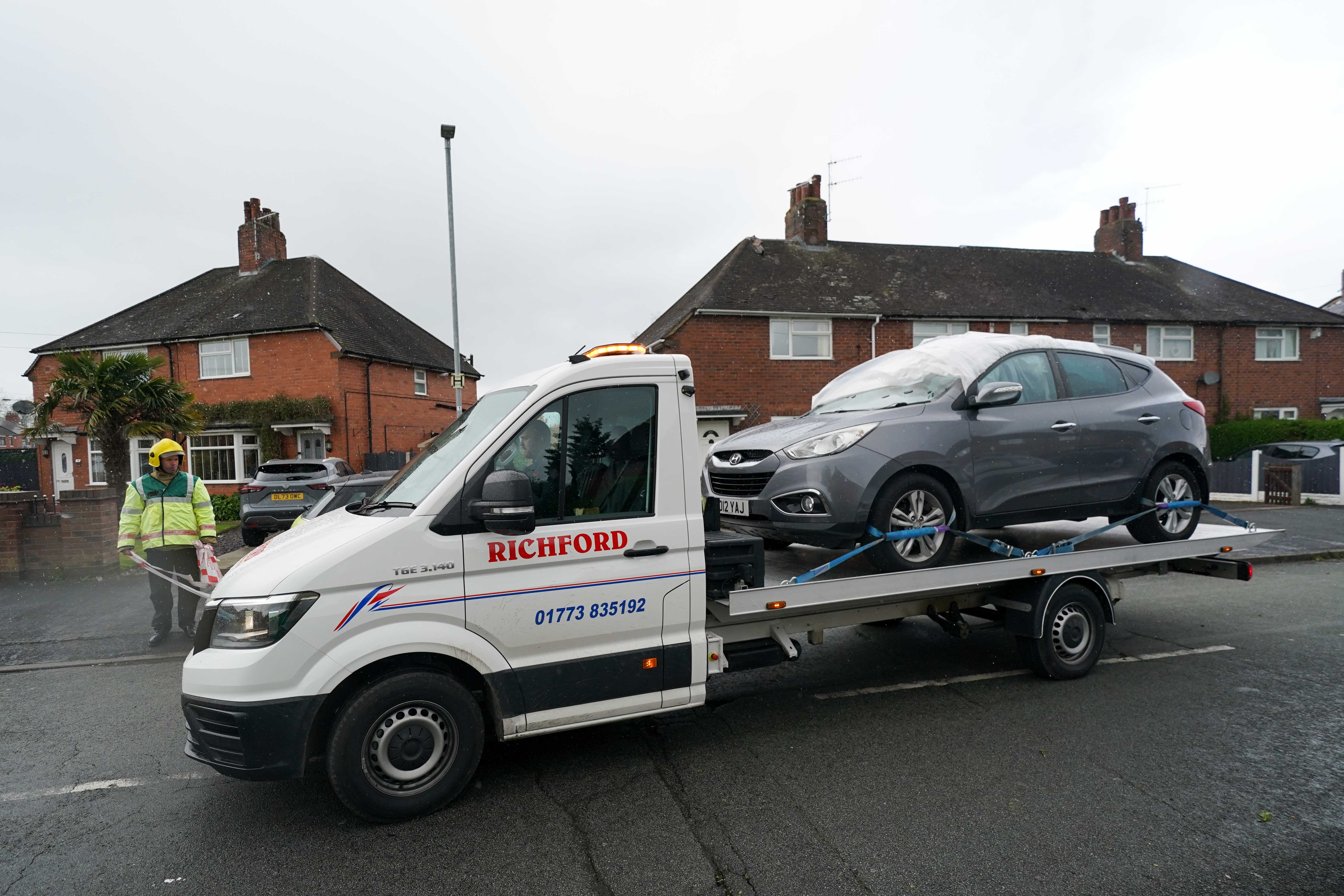 A damaged vehicle is towed away from St Gile's Road in Knutton, North Staffordshire