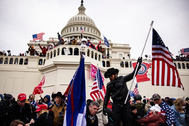 <p>Pro-Trump supporters storm the US Capitol following a rally with then president Donald Trump on January 6, 2021 in Washington, DC</p>
