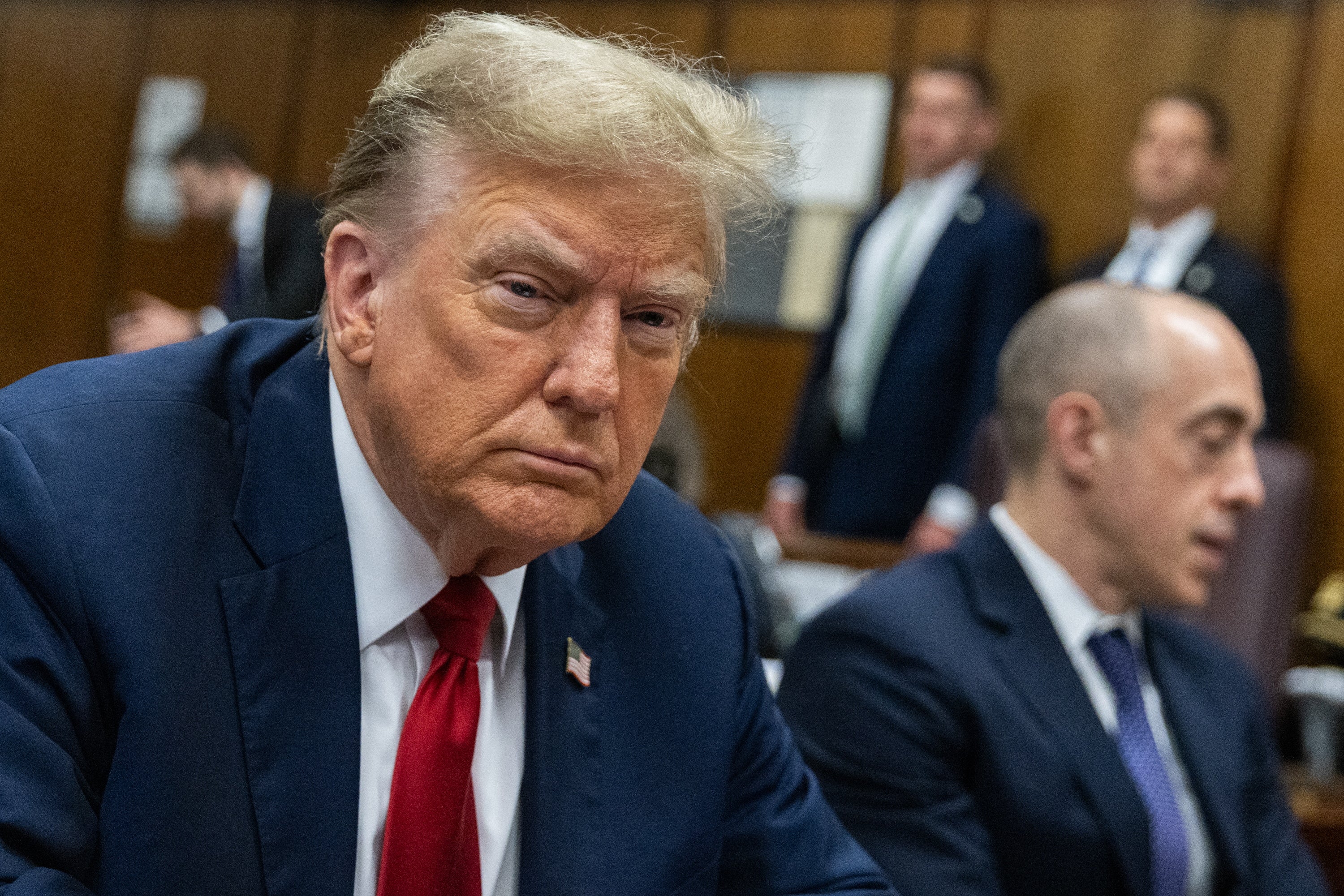 Donald Trump scowls as he sits at the defence table during day one of his first criminal trial in New York on 15 April.