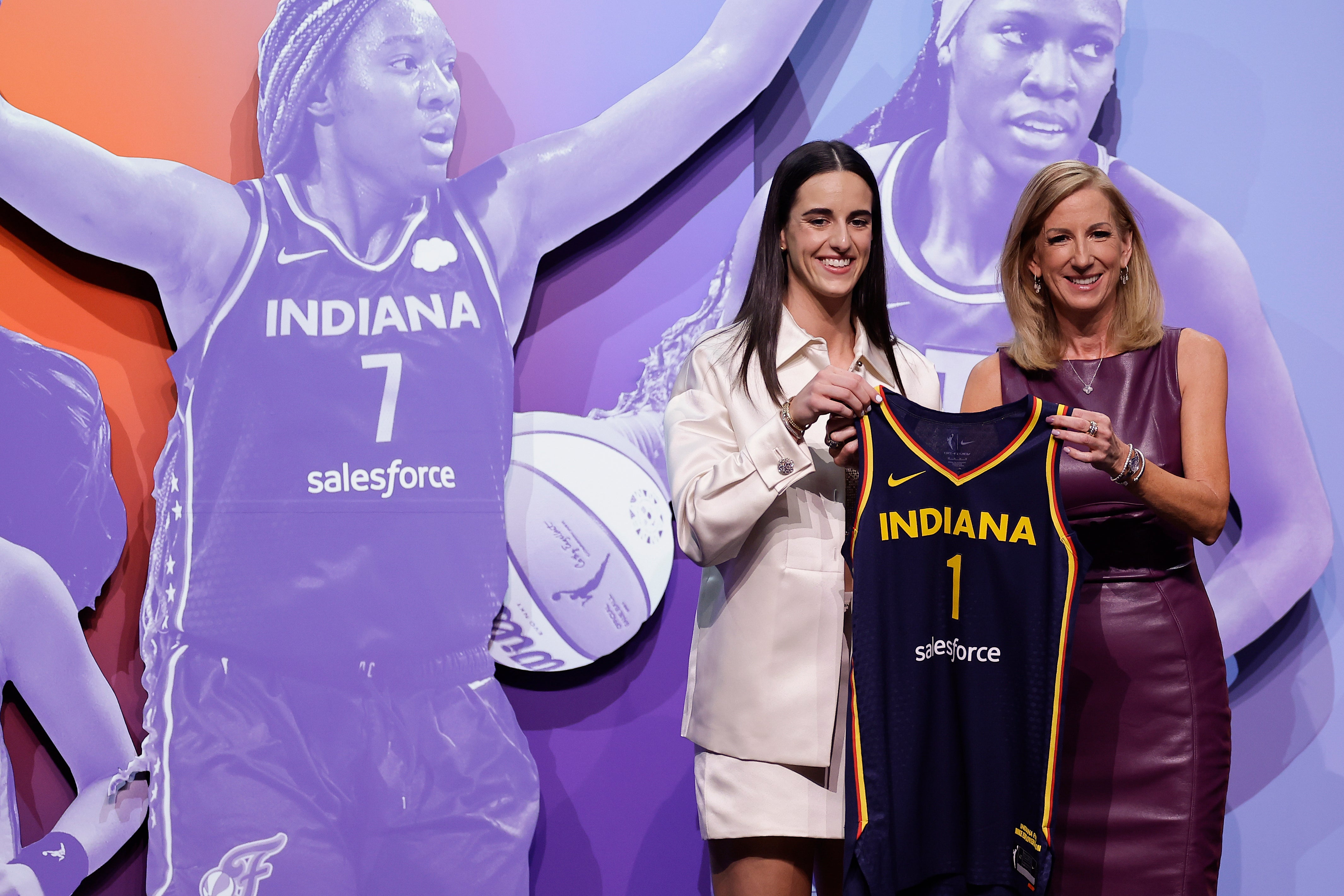 Iowa's Caitlyn Clark, left, poses for a photo with WNBA commissioner Cathy Engelbert after being selected first overall by the Indiana Fever during the first round of the WNBA basketball draft