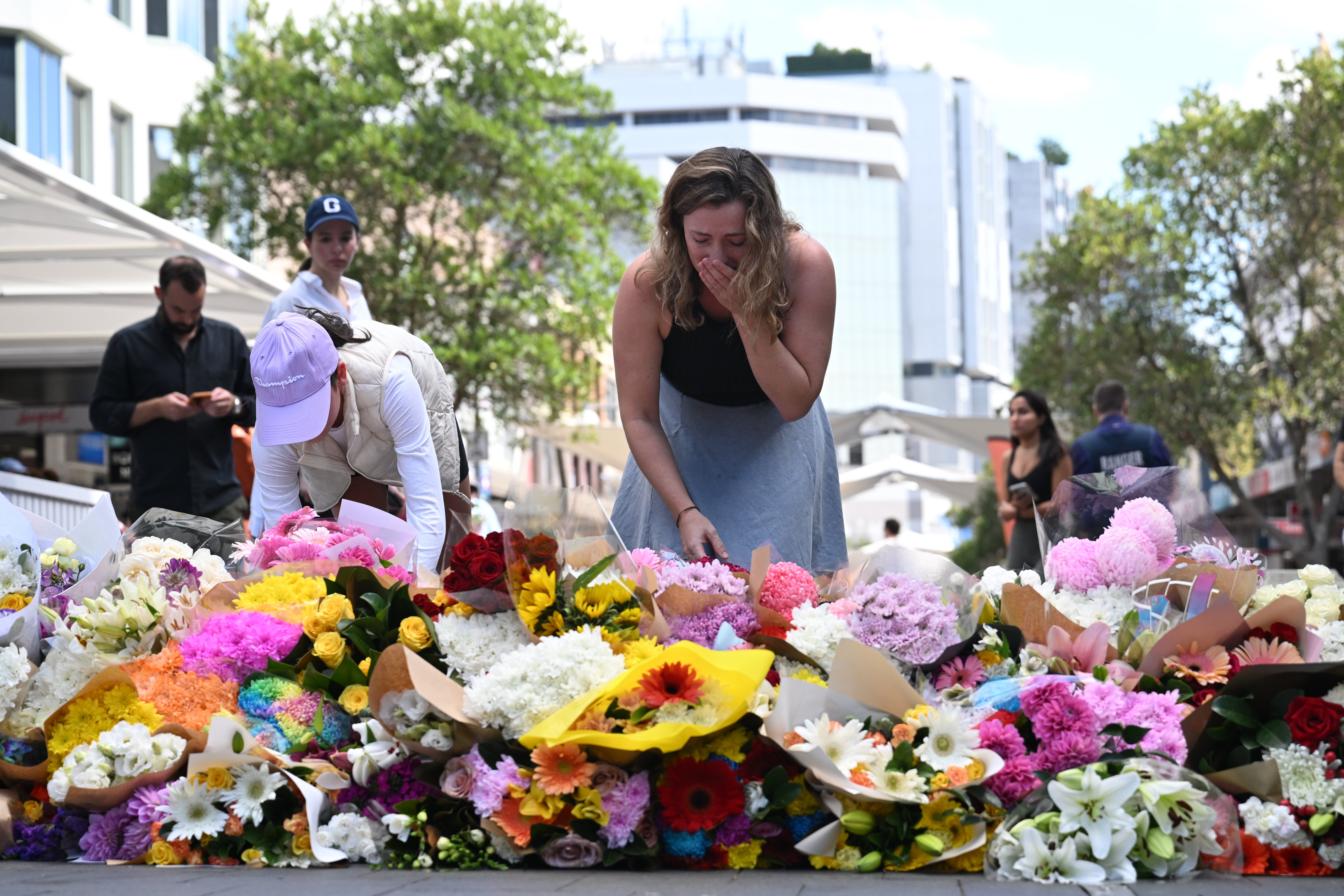 People pay their respects at the scene of the 13 April stabbing rampage at Bondi Junction in Sydney