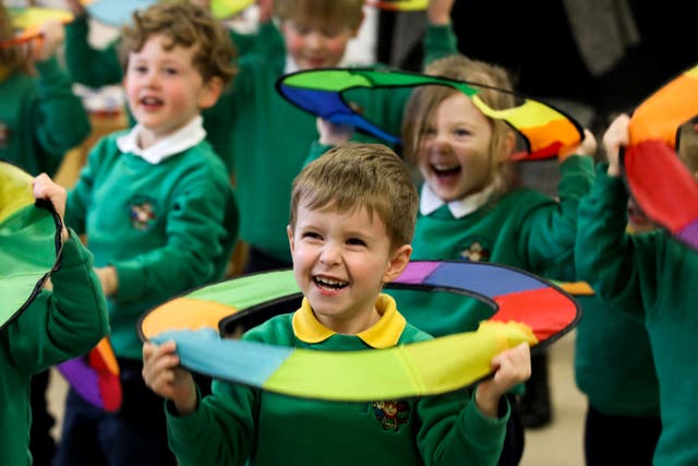 <p>Pupils play on the first day of the newly opened Bangor Integrated Nursery school, one of the two outliers at kindergarten age, for children aged three and four, in Bangor, on 15 March 2023</p>