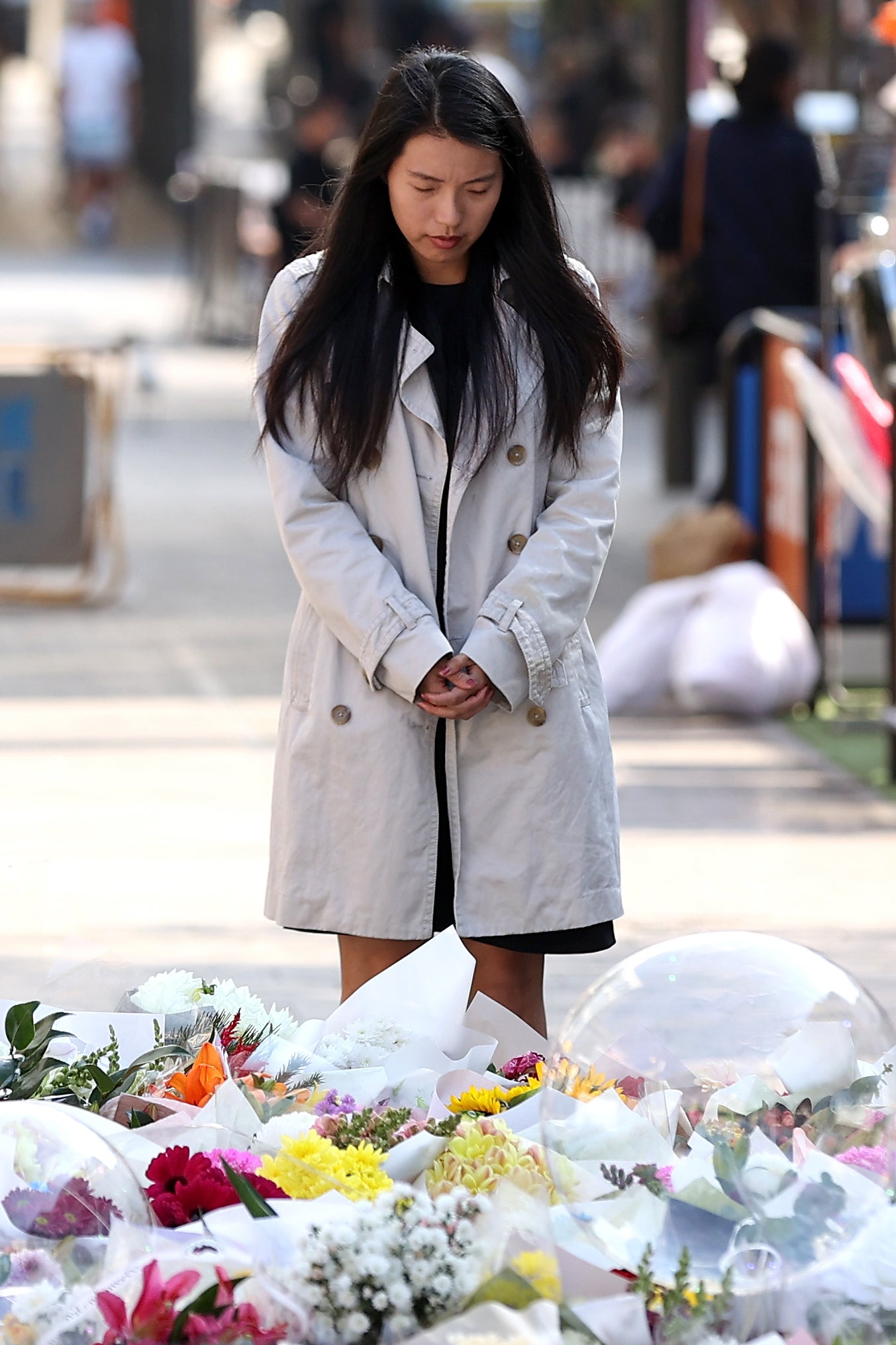 A woman takes a moment to remember those who died in the shopping centre attack