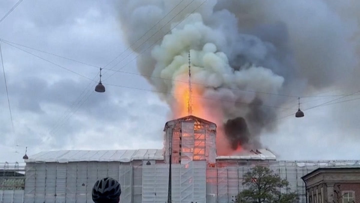 Moment 180ft spire collapses as blaze engulfs Copenhagen’s 400-year-old stock exchange