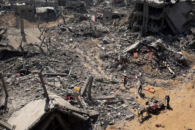 <p>People look for salvageable items amid the rubble of buildings destroyed during Israeli bombardment in Khan Yunis, on the southern Gaza Strip on April 16, 2024, as fighting continues between Israel and the Palestinian militant group Hamas.</p>