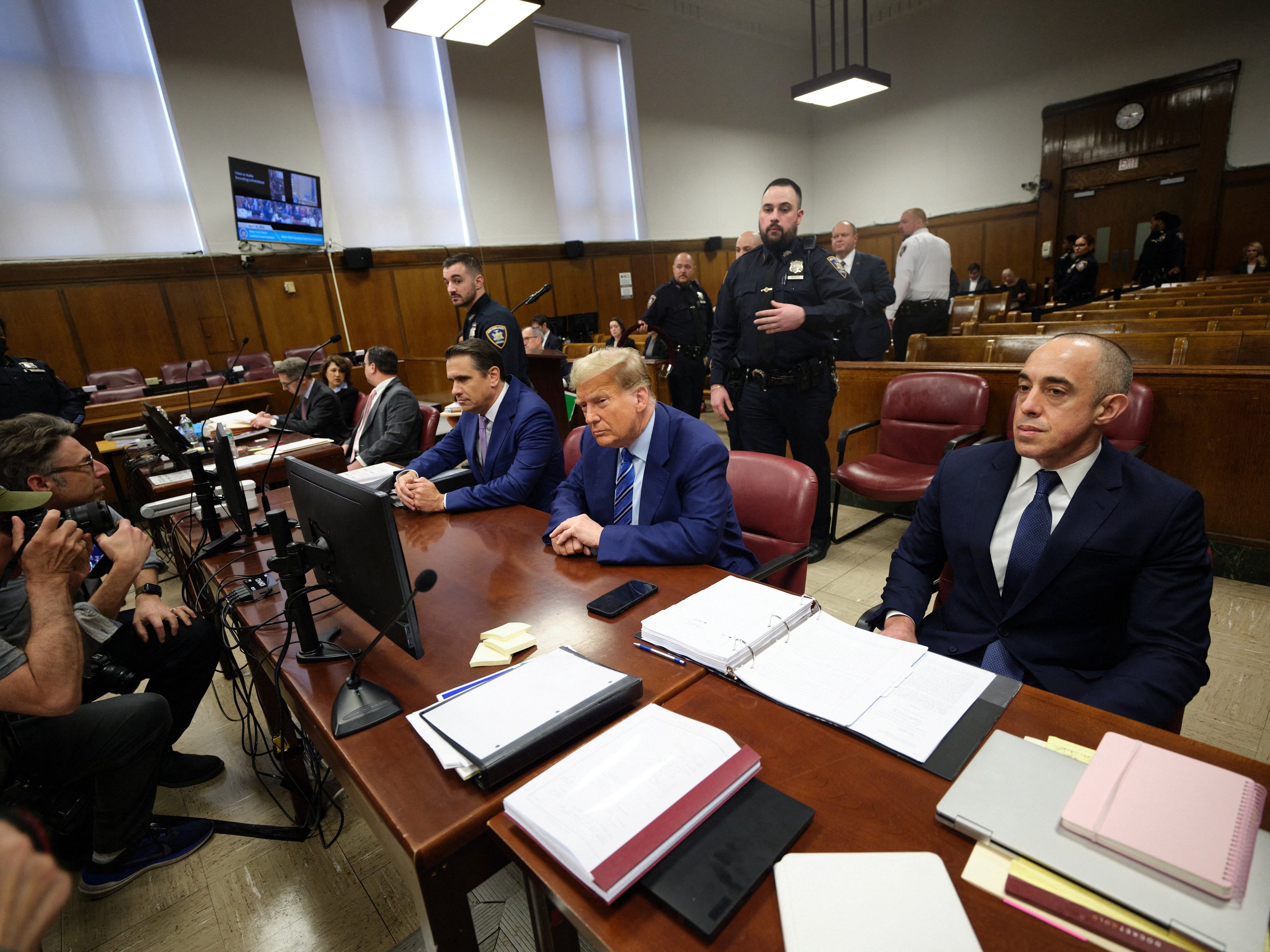 Lawyers Todd Blanche and Emil Bove surround Trump in the courtroom with attorneys on the trial’s second day