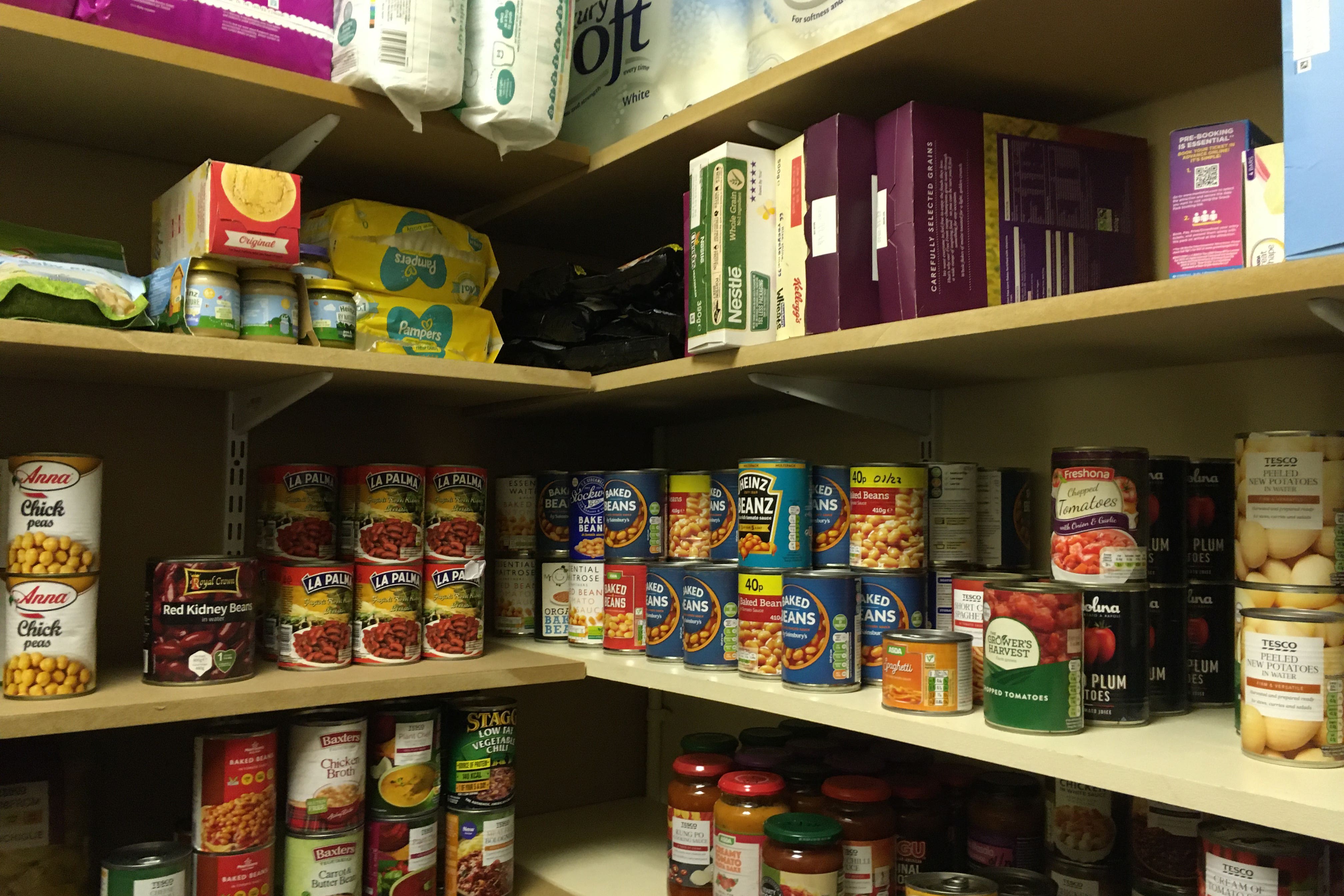 A secondary school store cupboard for tinned foods, cereal, baby food, toilet roll, and nappies used to create parcels for families of pupils in need (University of Bristol/PA)