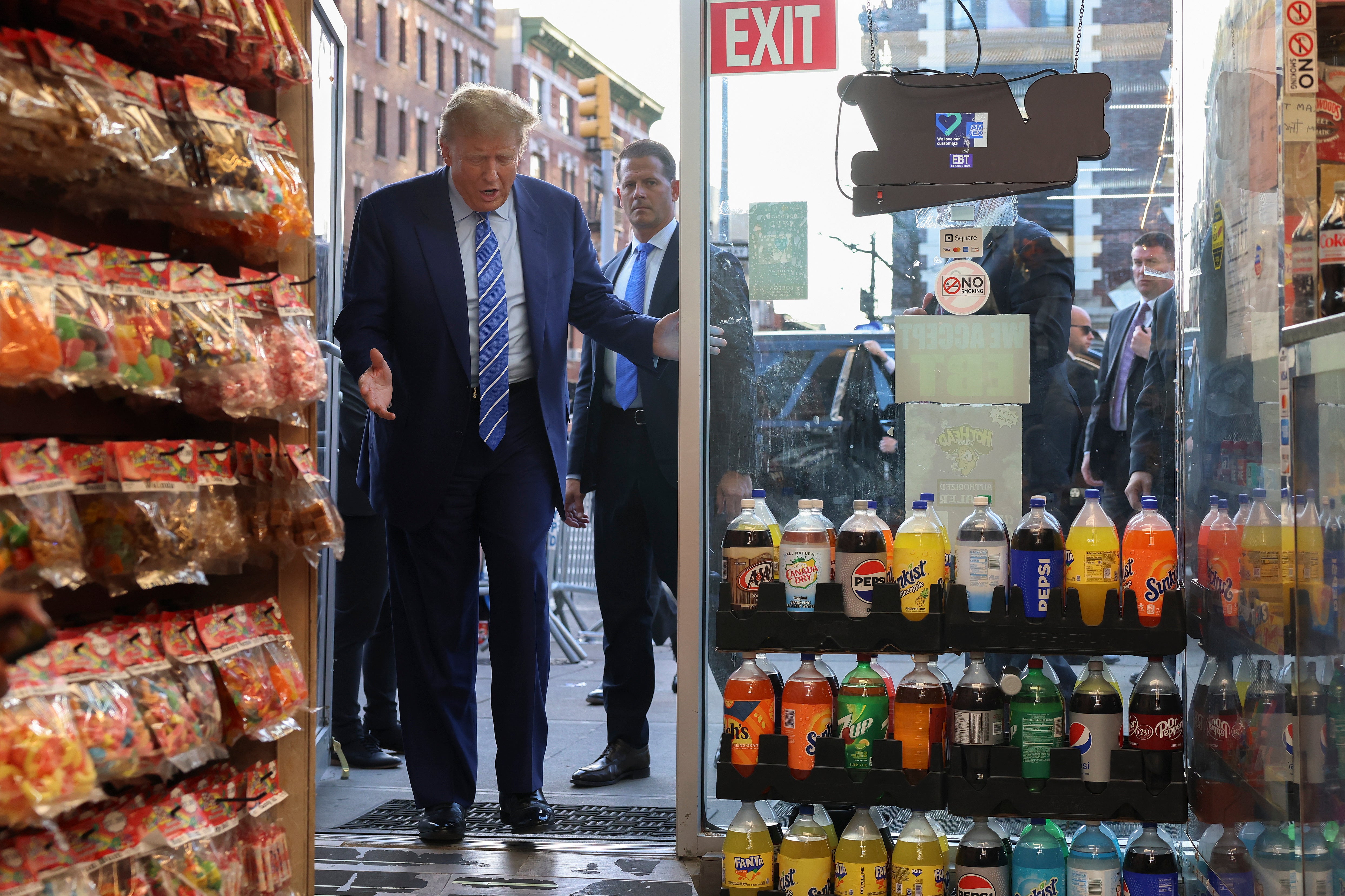 Former president Donald Trump reacts as he enters the Sanaa convenience store in Harlem on Tuesday afternoon