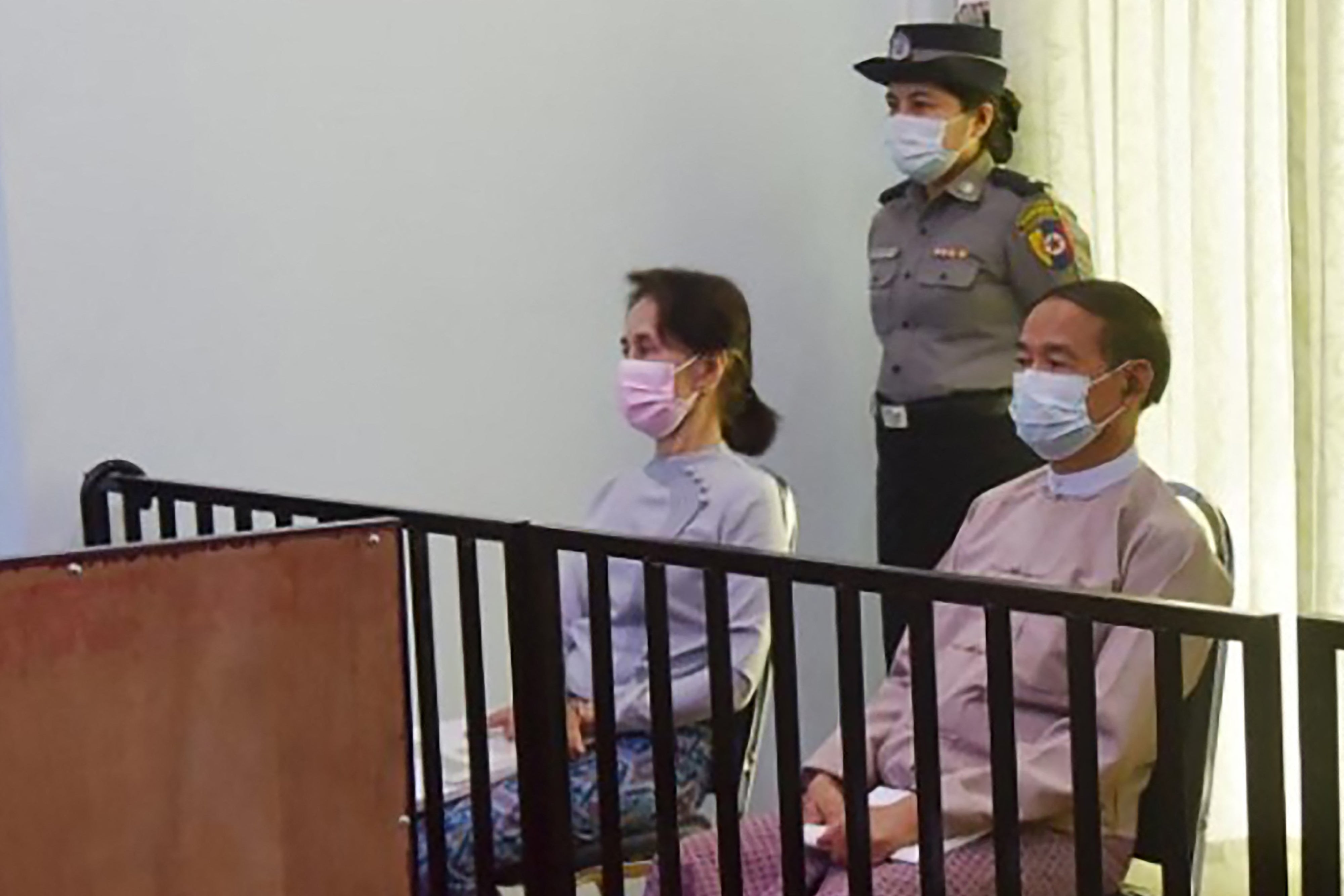 File: Image released by Myanmar in 2021 shows detained civilian leader Aung San Suu Kyi (L) and detained president Win Myint (R) during their first court appearance in Naypyidaw