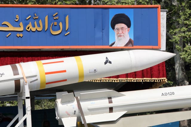 <p>File: An Iranian military truck carries parts of a Sayad 4-B missile past a portrait of supreme leader Ayatollah Ali Khamenei </p>