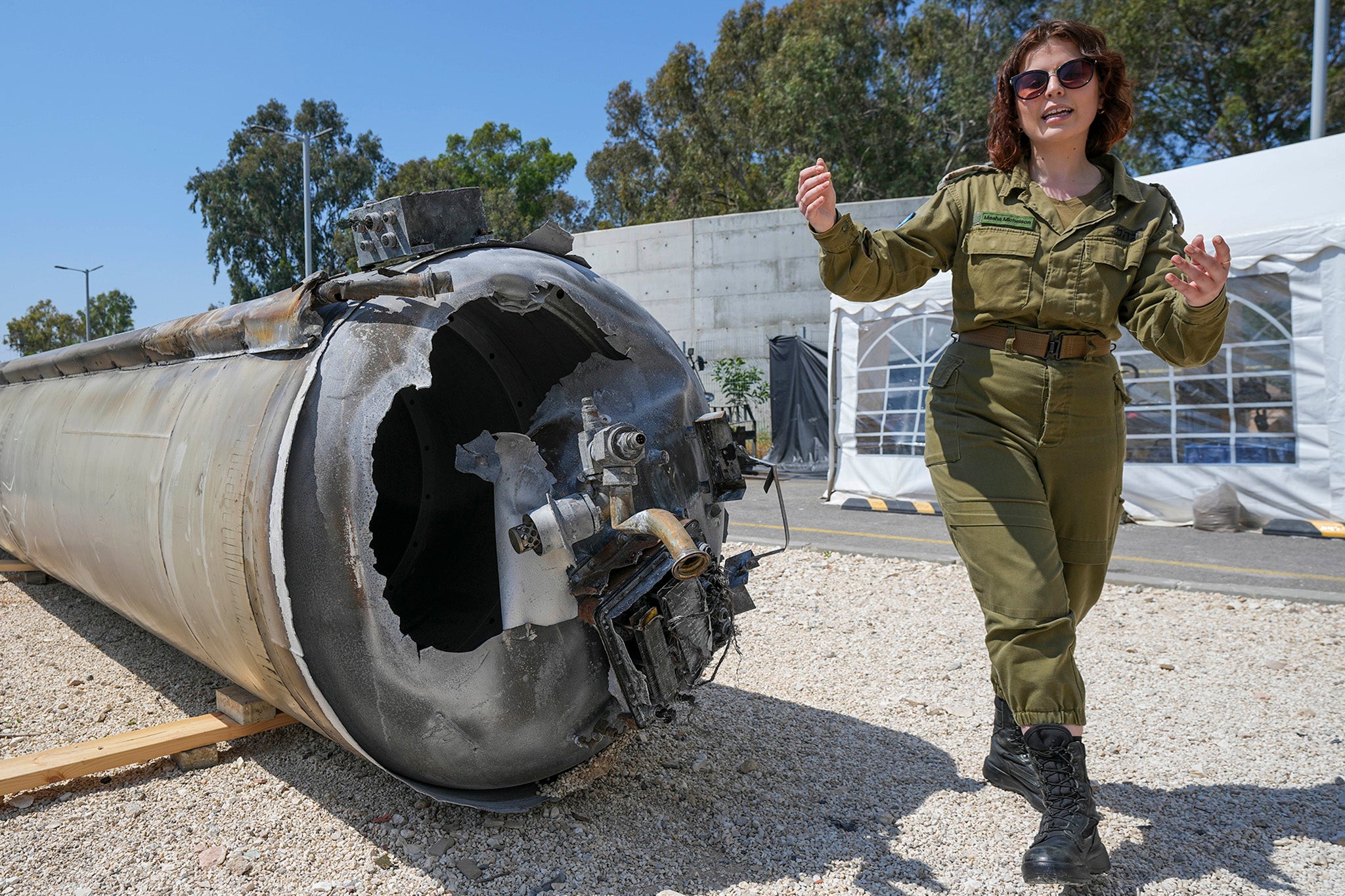 Israeli military deputy head of the IDF international press department, first lieutenant Masha Michelson, displays to the media one of the intercepted Iranian ballistic missiles