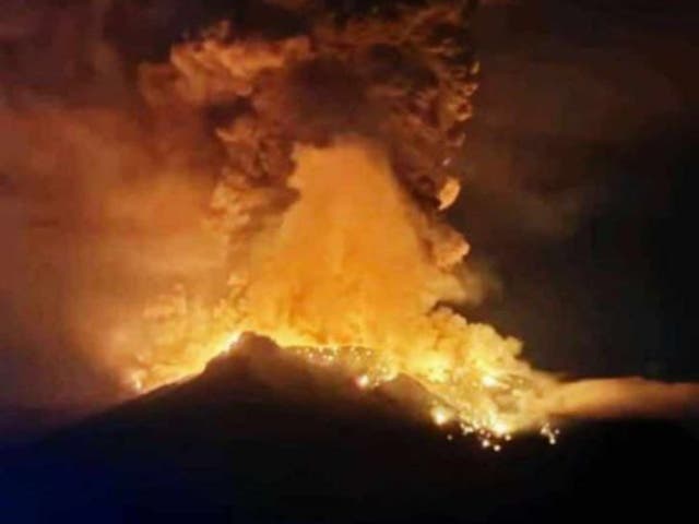 <p>A handout photo made available by Indonesian Center for Volcanology and Geological Hazard Mitigation shows smoke an lava erupting from Mount Ruang</p>