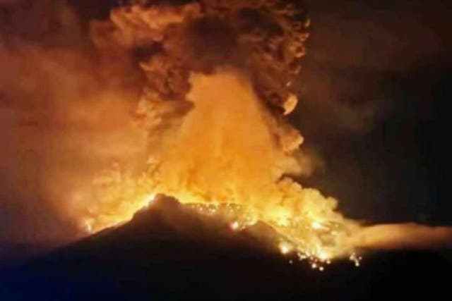 <p>A handout photo made available by Indonesian Center for Volcanology and Geological Hazard Mitigation shows smoke an lava erupting from Mount Ruang</p>