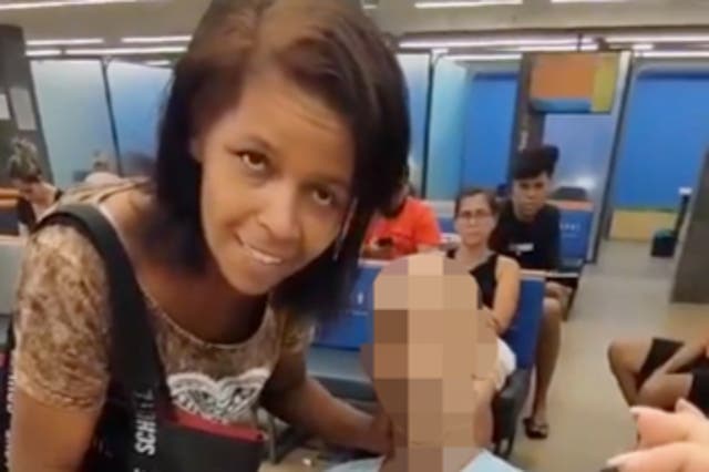 <p>Eika de Souza Vieira Nunes, left, at a bank in Brazil where she attempted to use the corpse of a man she claimed to be her uncle to cosign a bank loan</p>