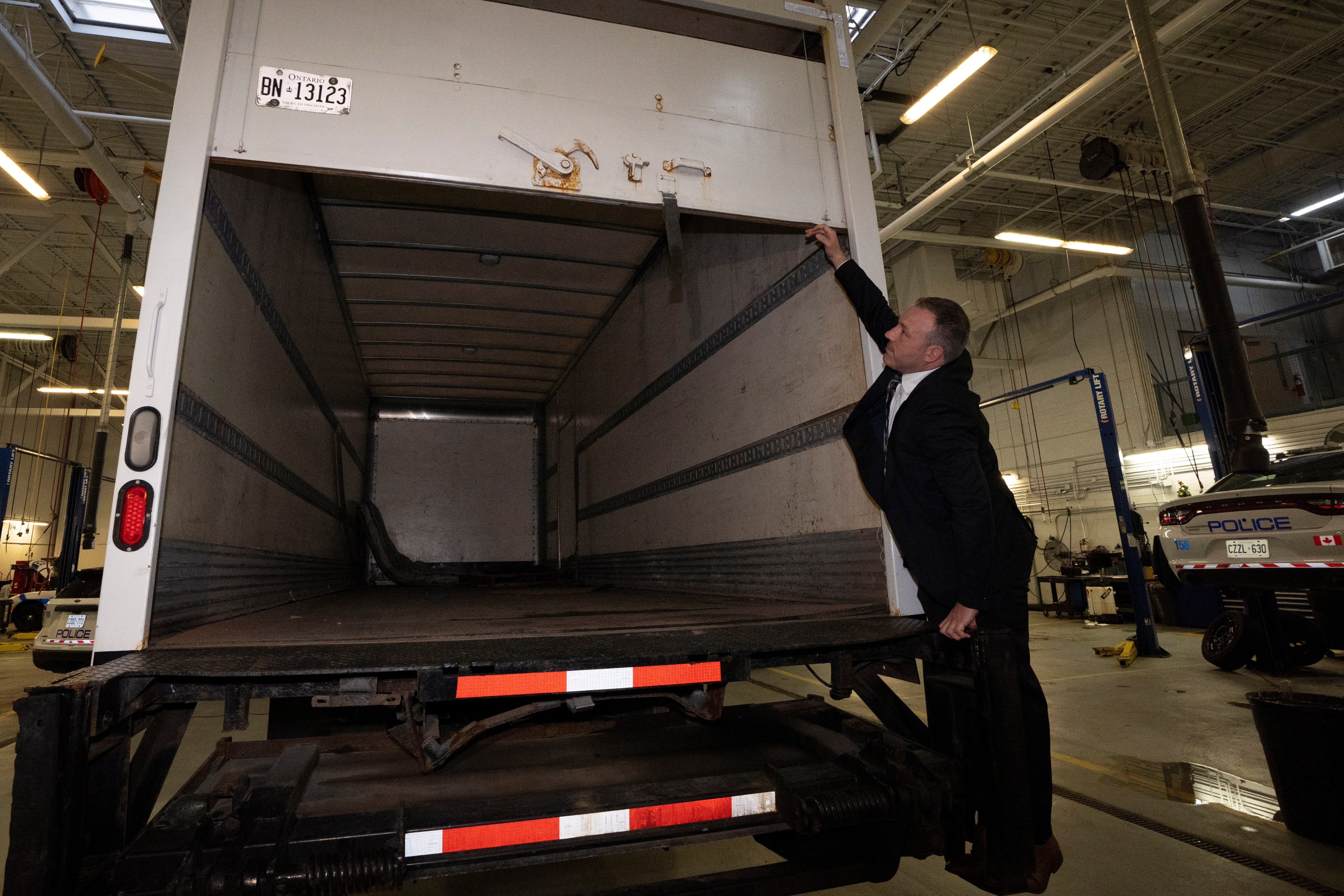 Police officers open the back of a recovered truck during a press conference regarding Project 24K a joint investigation into the theft of gold from Pearson International Airport, in Brampton, Ontario, on Wednesday, April 17, 2024