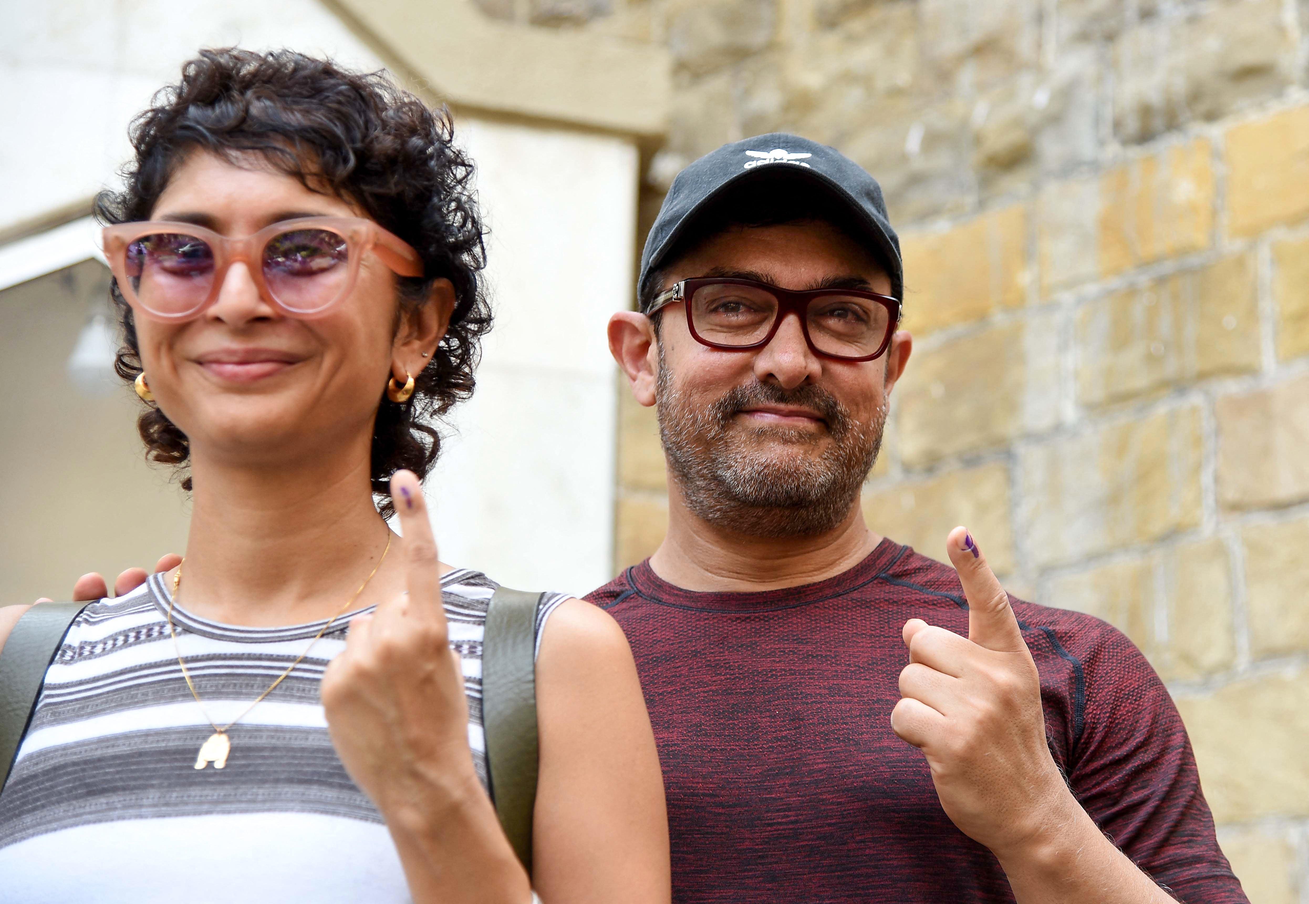 Indian Bollywood actor Aamir Khan (R) along with his wife and film director Kiran Rao (L) after casting their vote in Mumbai on April 29, 2019