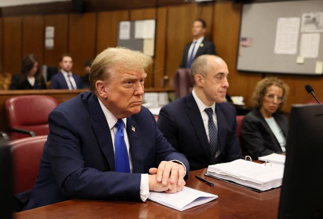 <p>Former US president Donald Trump sits at the defence table at his criminal trial on charges of falsifying business records in New York </p>