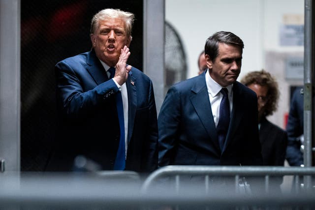 Former President Donald Trump speaks alongside attorney Todd Blanche as they return from a lunch break in his trial at Manhattan criminal court in New York on Thursday, April 18, 2024