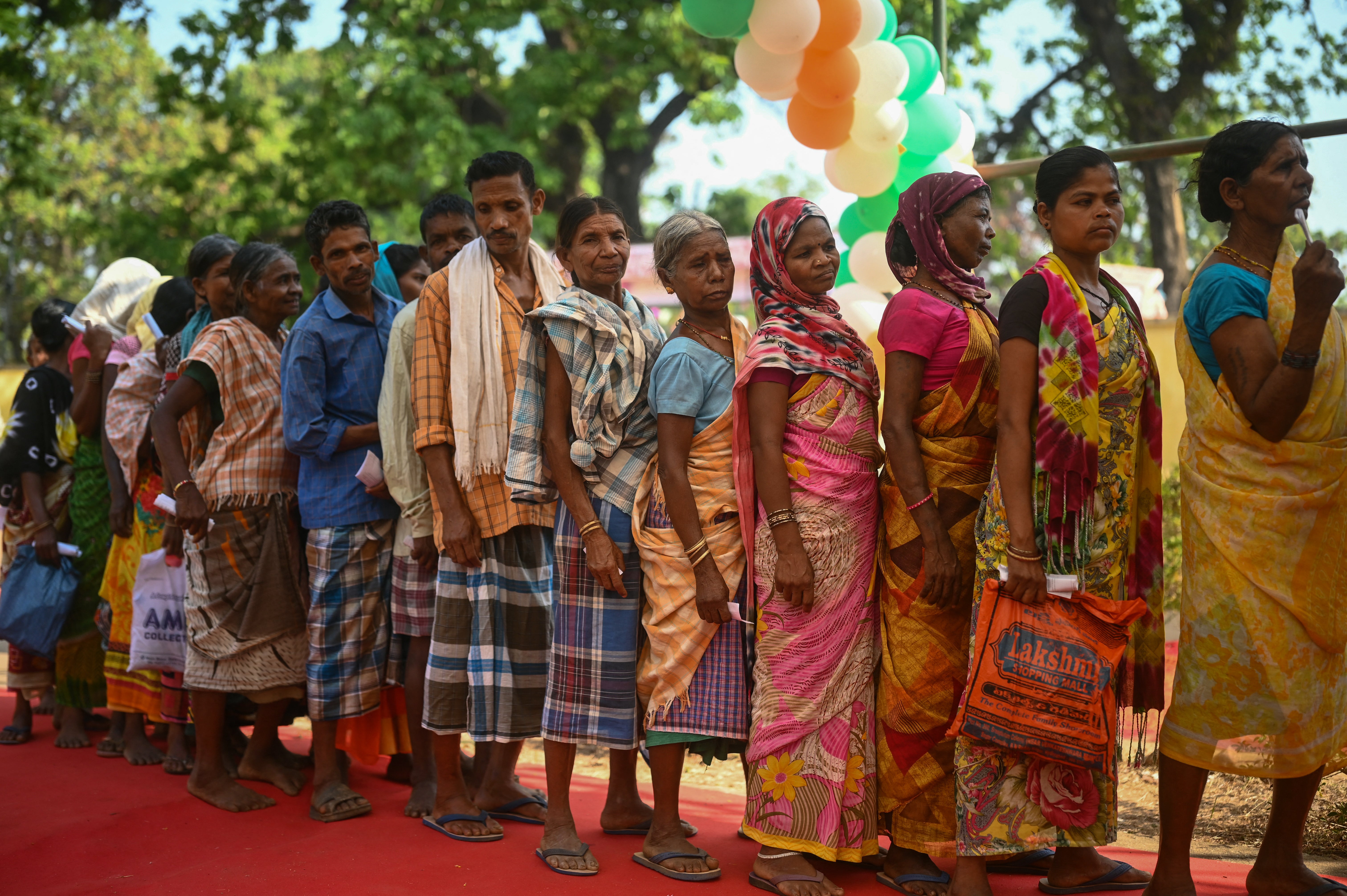 People line up outside a polling station in Dugeli village of Dantewada in central India’s Chhattisgarh state on 19 April 2024