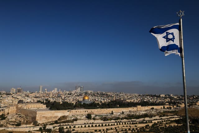 <p>An Israeli flag flies on the Mount of Olives overlooking the Al Aqsa mosque compound and the city skyline in Jerusalem on 19 April 2024</p>