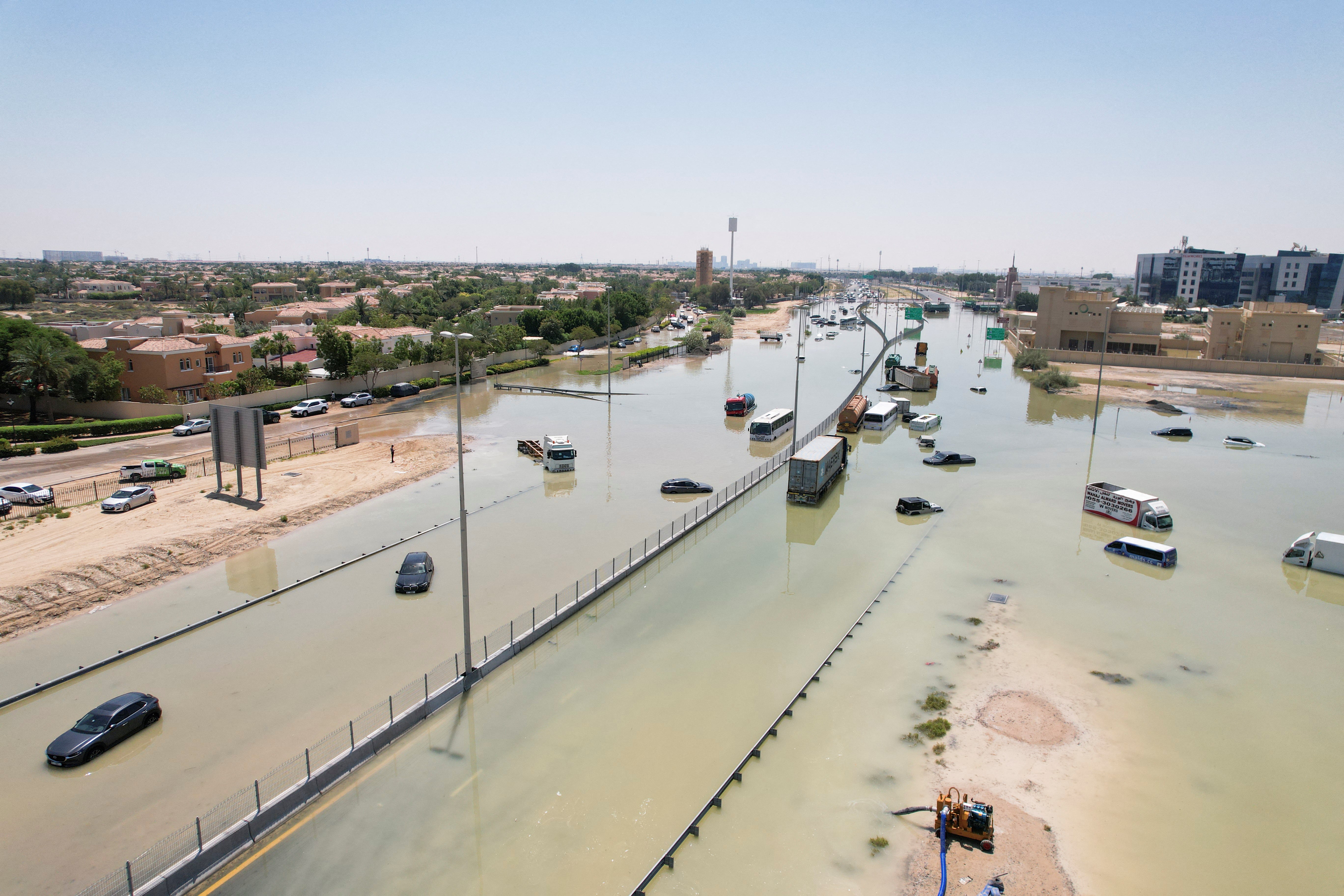 A drone view of cars and trucks lying partially submerged following heavy rainfall in Dubai