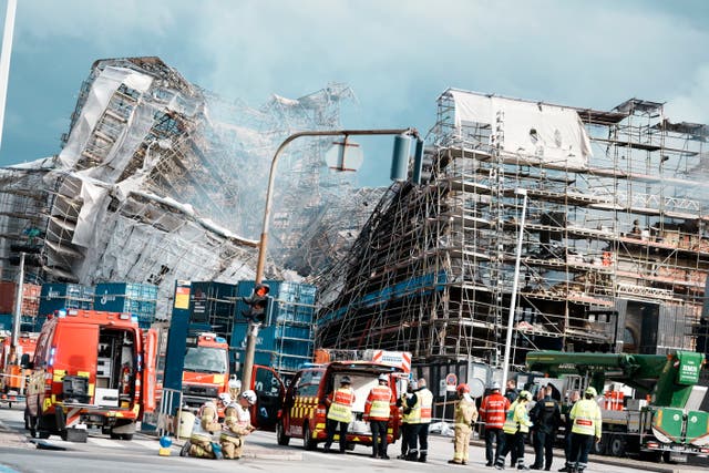 <p>The outer wall of the Stock Exchange collapse towards Boersgade, Copenhagen, Thursday, April 18, 2024</p>