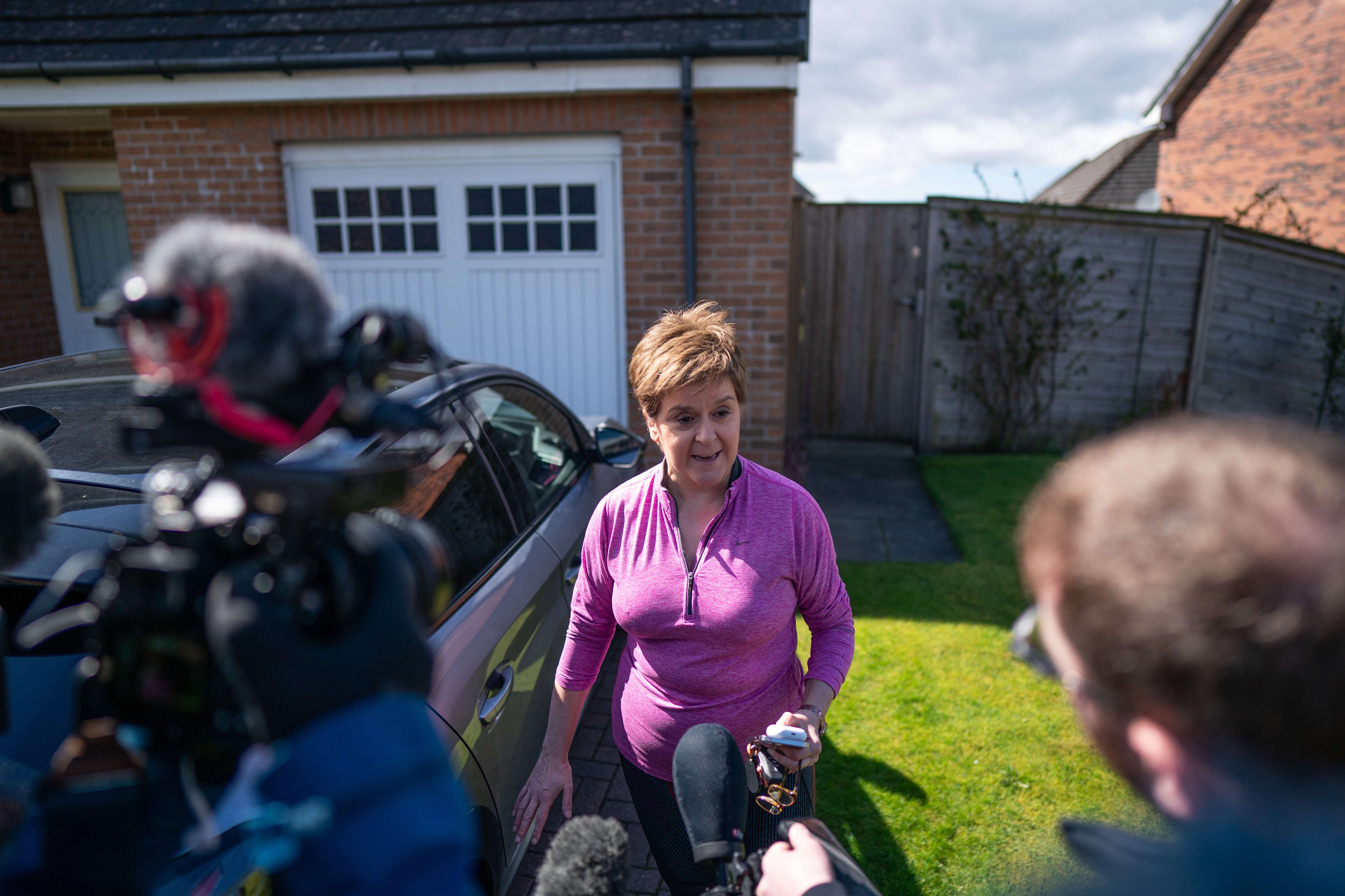 Nicola Sturgeon speaks to reporters outside her home near Glasgow after her husband was charged by police