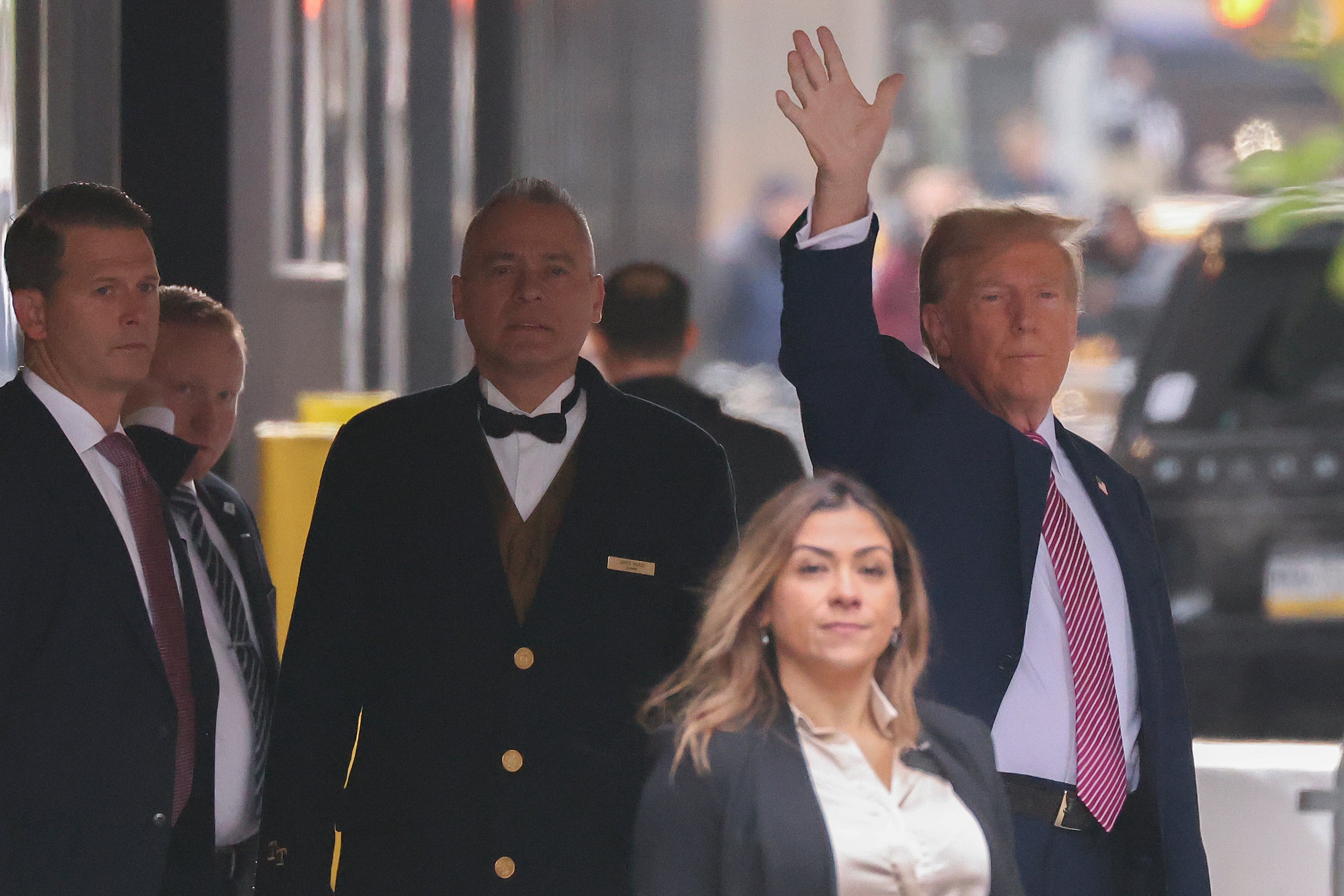 Donald Trump waves to people looking on as he leave Trump Tower on 19 April