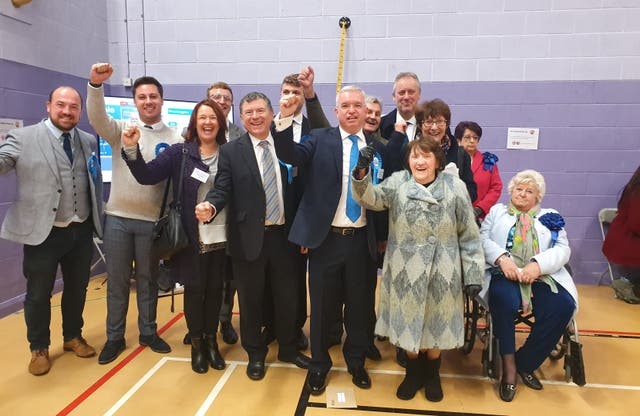 <p>Katie Fieldhouse (top right with pink jacket) looks unimpressed as Mark Menzies celebrates his emphatic election victory in 2019 </p>