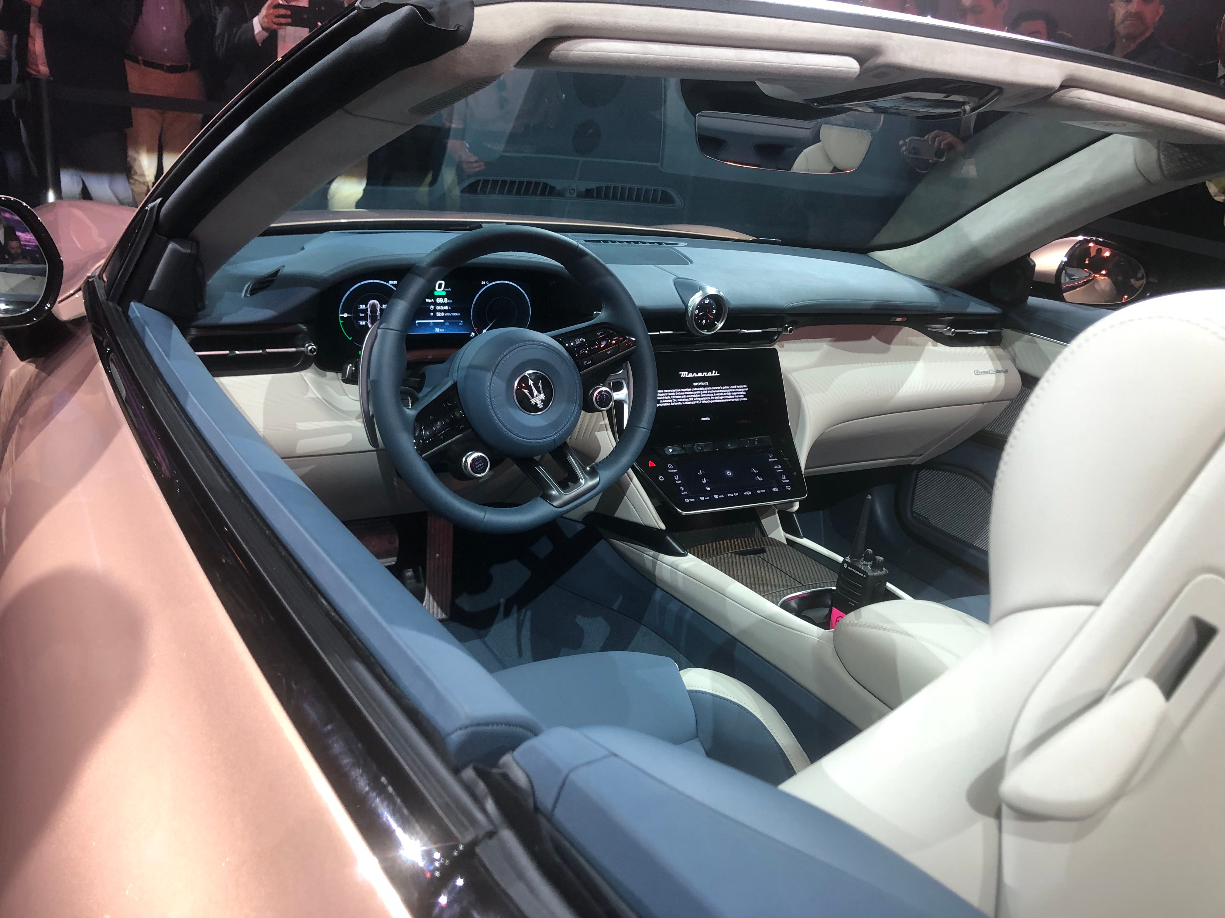 The interior is snug and practical, and two touchscreens are provided for the driver