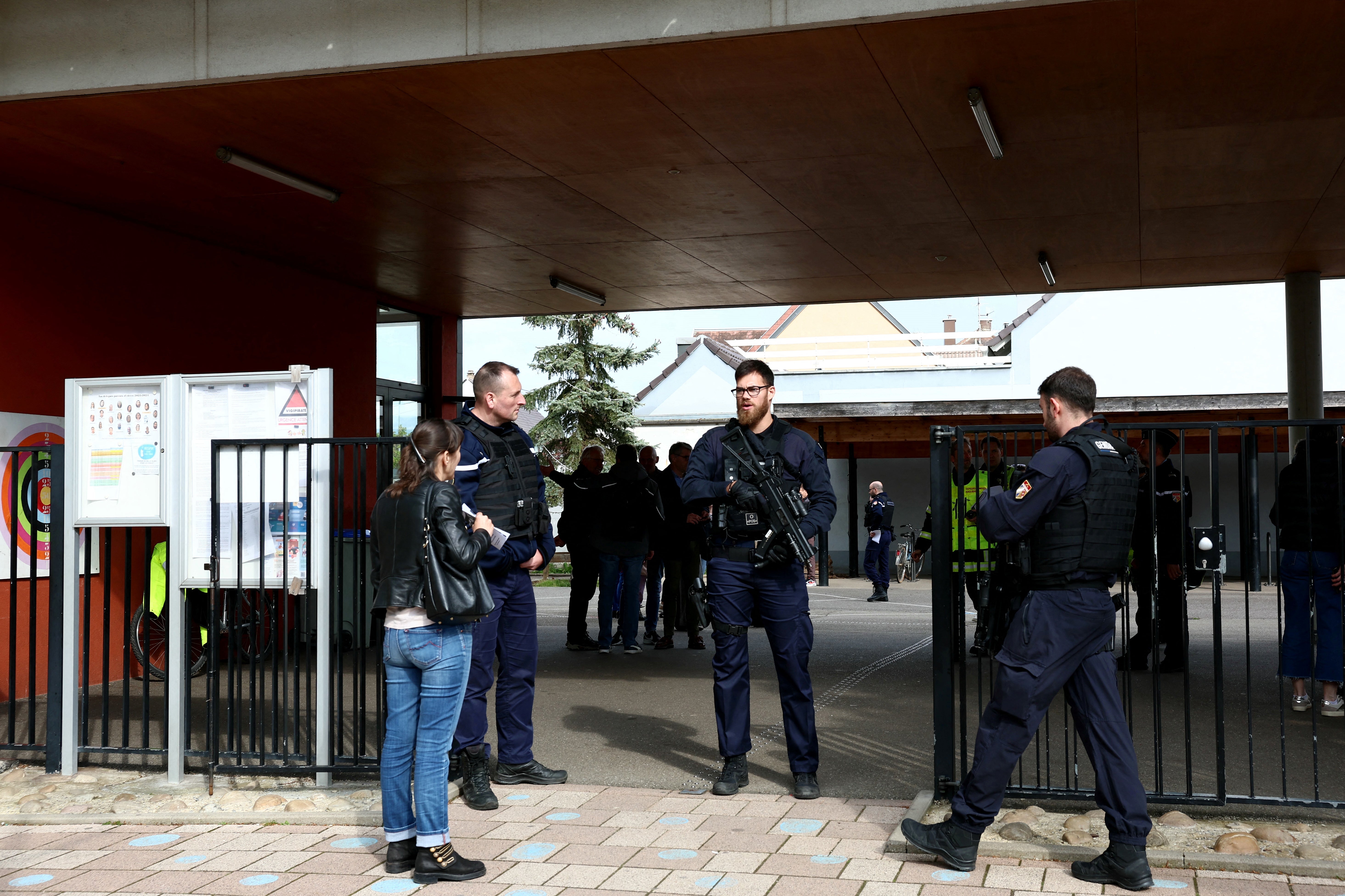 Gendarmes control the access to a school in the eastern France city of Souffelweyersheim while investigations are underway