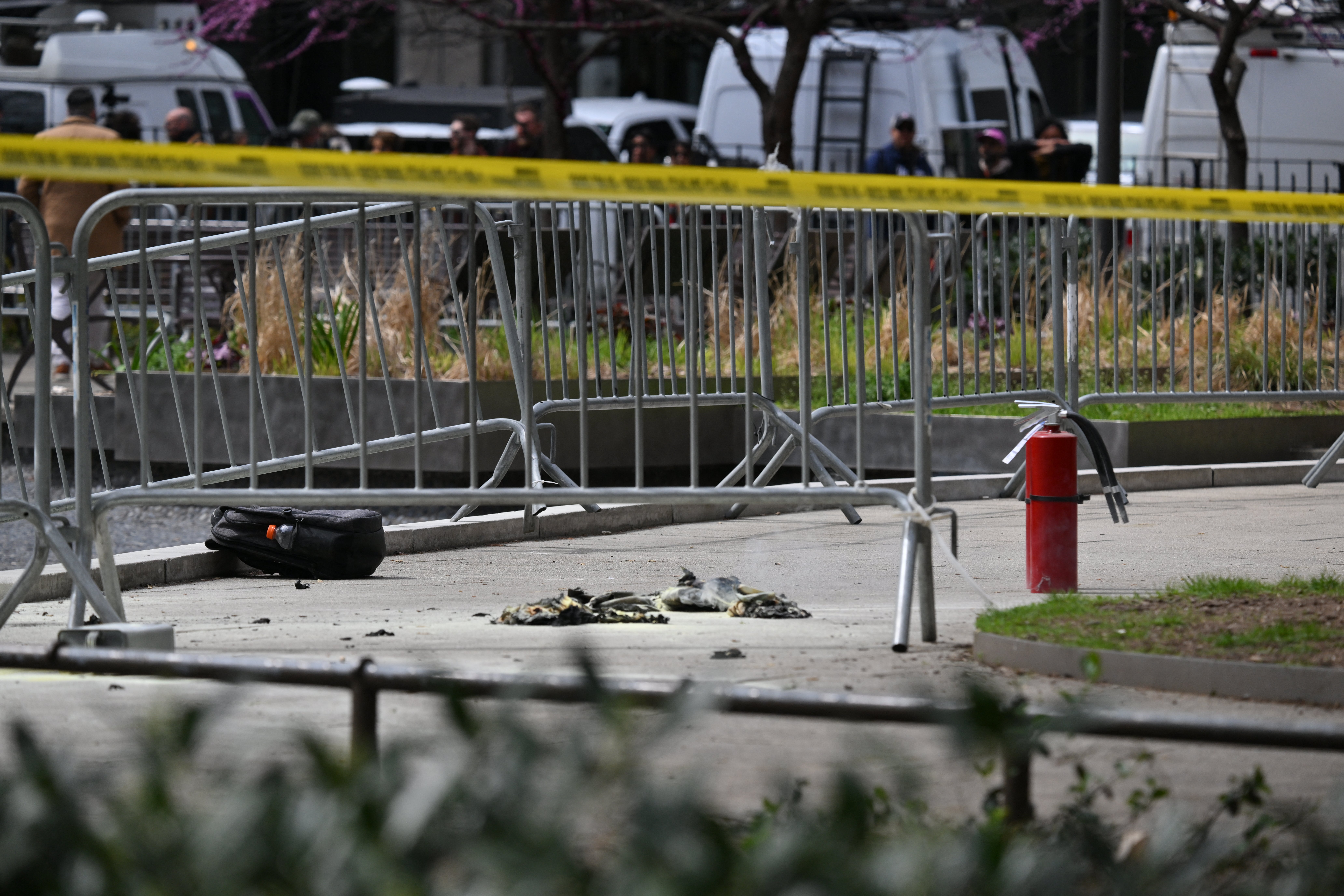 A fire extinguisher remains on the scene outside the park where Azzarello self-immolated on Friday