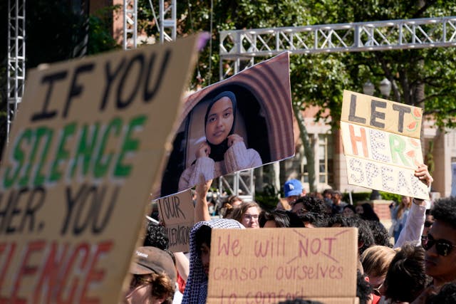 <p>Students hold up a photo of University of Southern California 2024 valedictorian Asna Tabassum in protest of her cancelled commencement speech </p>