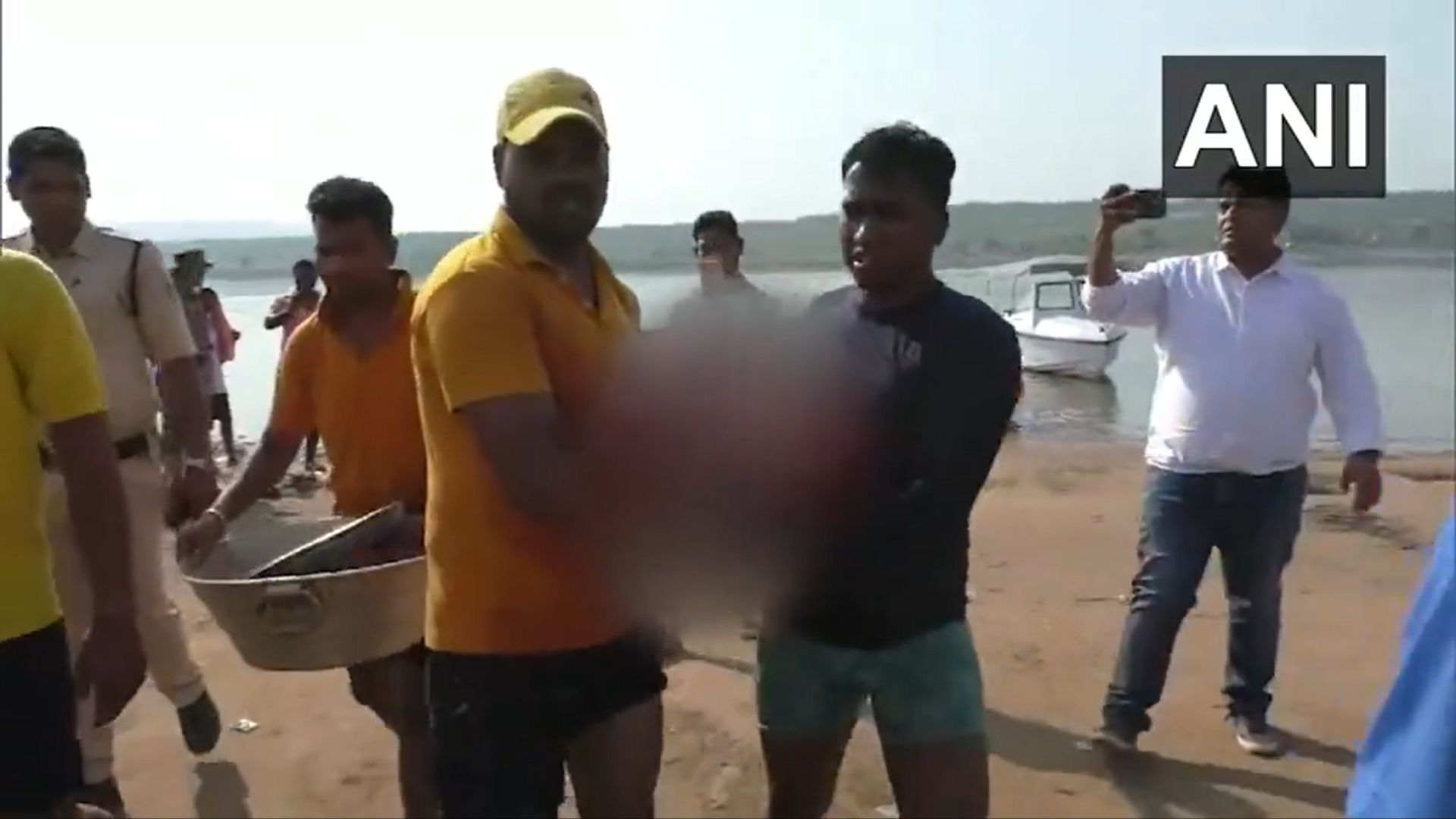 A video grab shows rescue workers retreiving bodies from the river after boat capsizes in Odisha, India