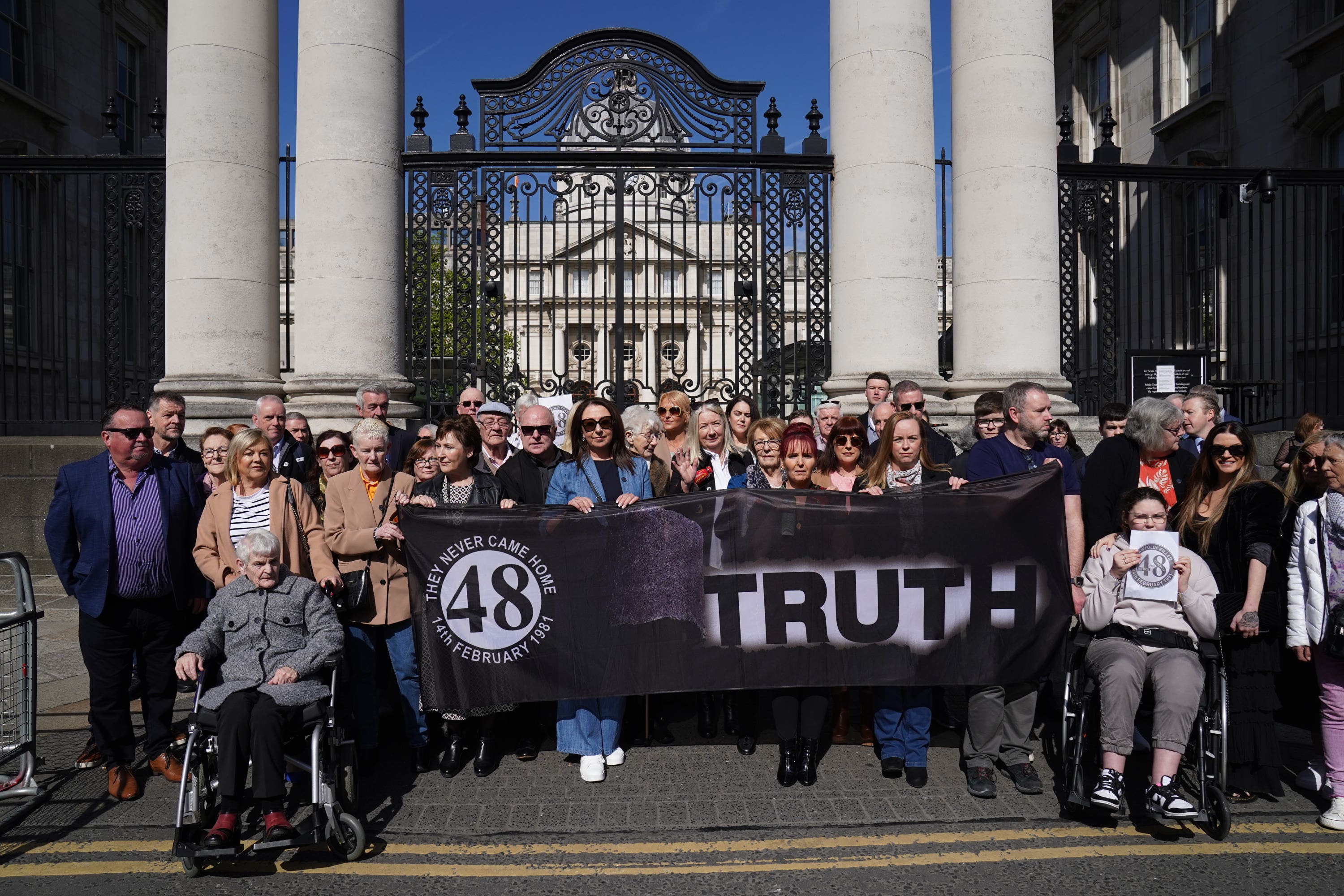 Families of the survivors and victims of the Stardust gather outside Government Buildings in Dublin (Brian Lawless/PA)