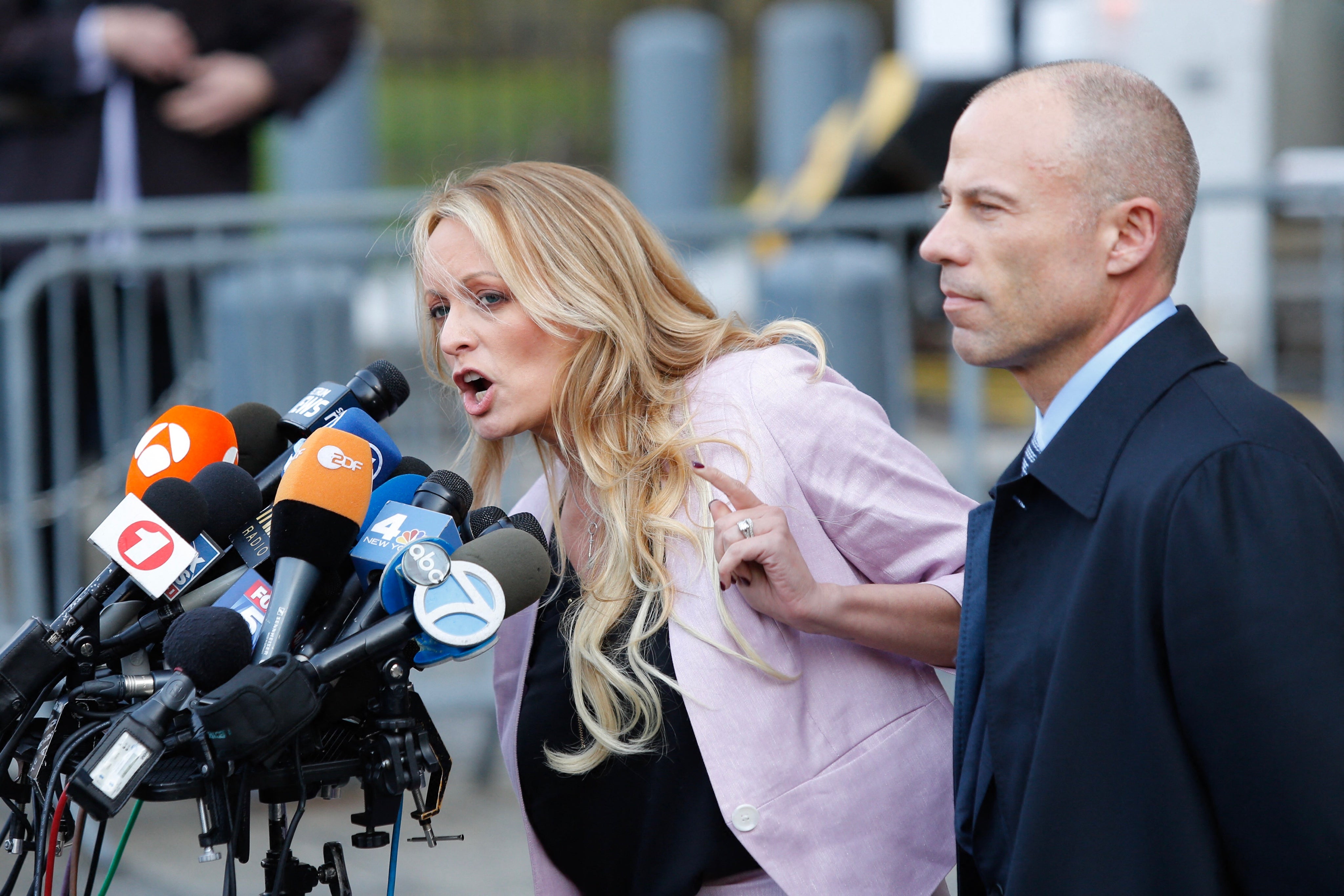Adult film actor Stephanie Clifford, also known as Stormy Daniels, speaks outside US Federal Court with her then-lawyer Michael Avenatti in 2018